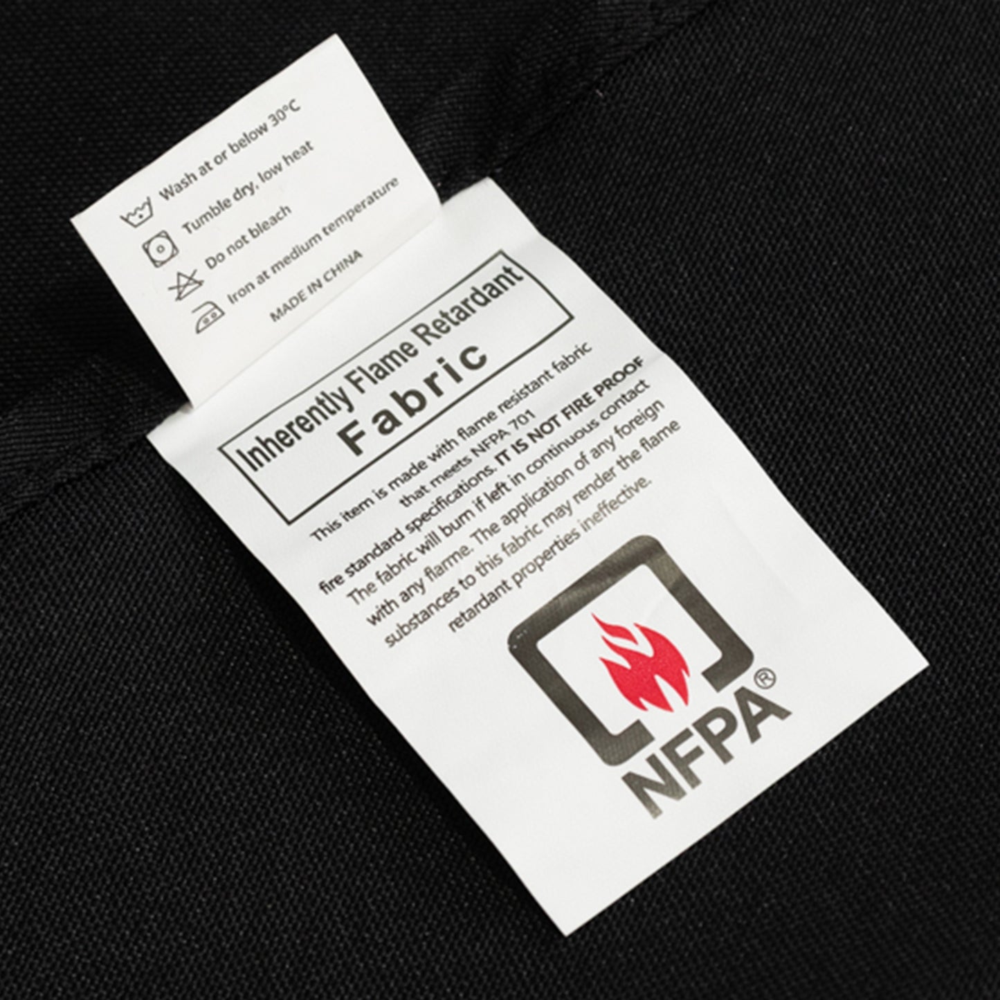 Fire retardant black tablecloth with care label.