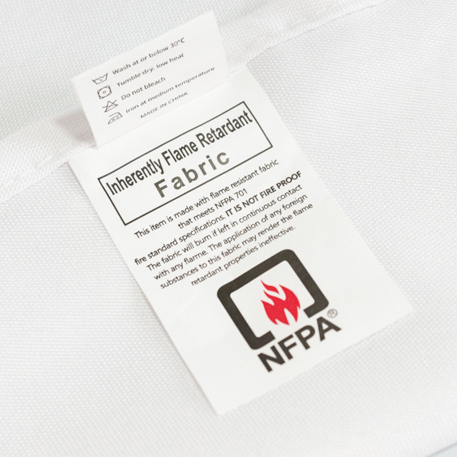 White fire retardant fitted tablecloth for rectangular tables.
