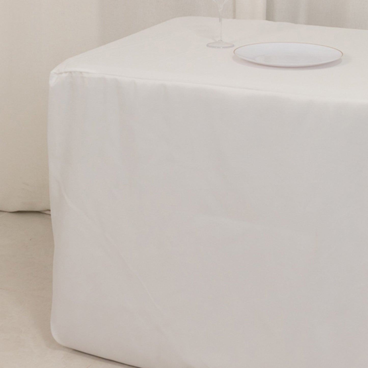White fitted tablecloth on a rectangular table.