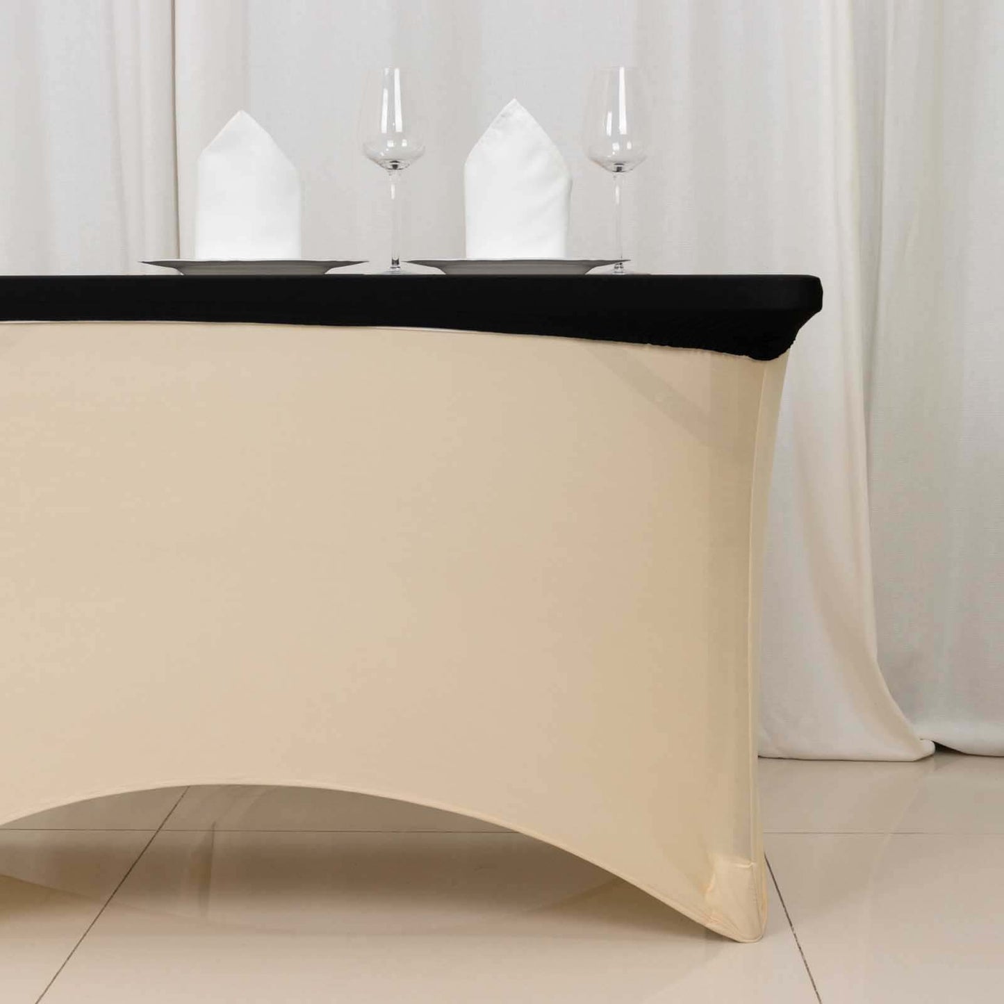 Black fitted tablecloth for 48"x30" tables, wrinkle-free and stretchable.