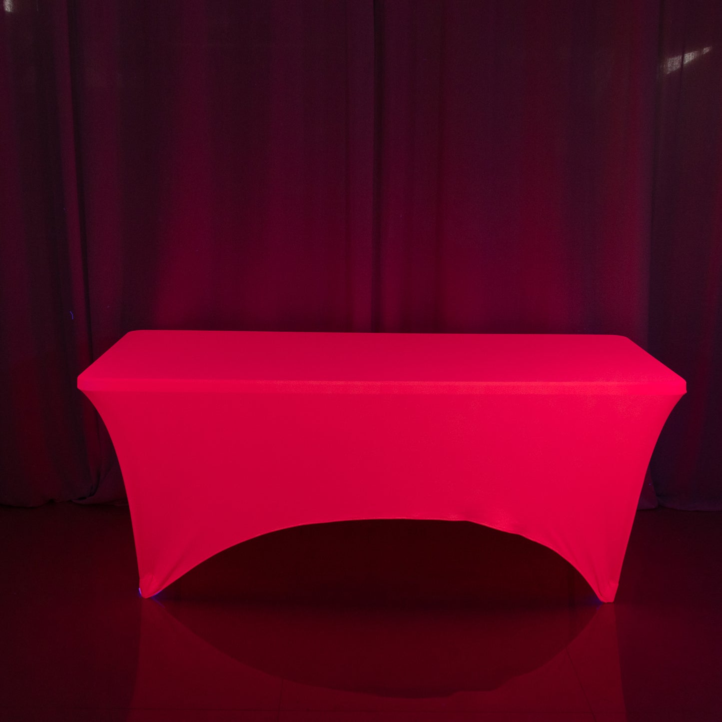 Glow Neon Fuchsia Fitted Spandex Tablecloth on a table. #whtbkgd
