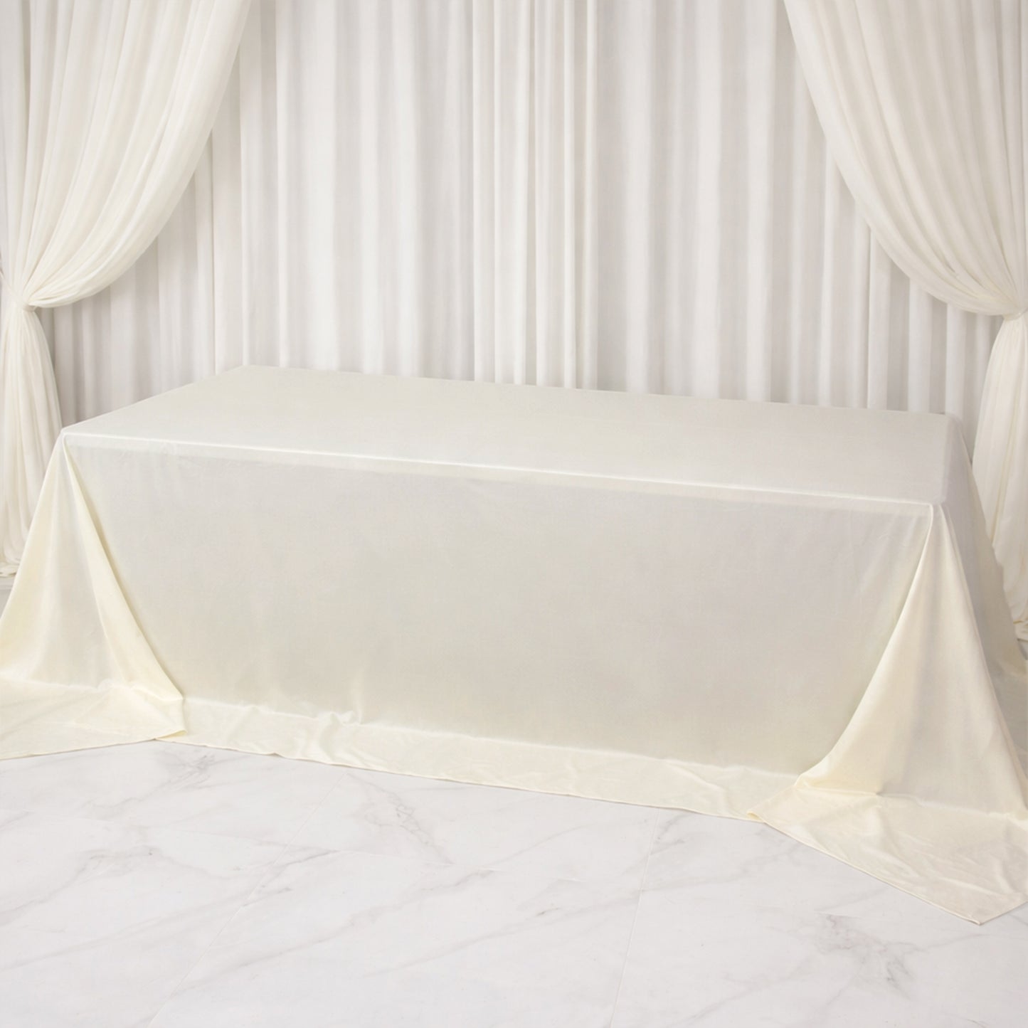 Ivory rectangular tablecloth for 8ft tables, wrinkle-free and stain-resistant.