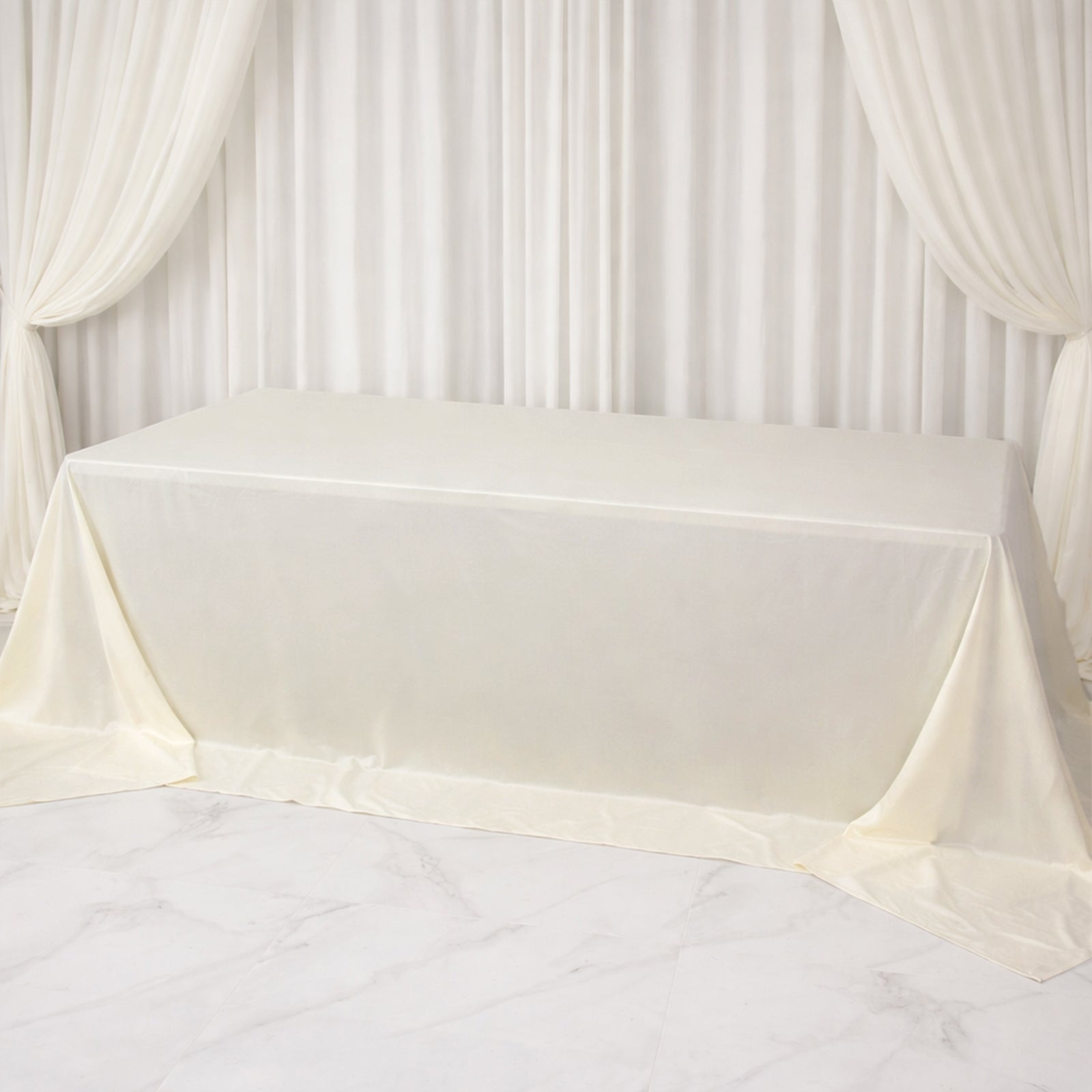 Ivory rectangular tablecloth for 8ft tables, wrinkle-free and stain-resistant.