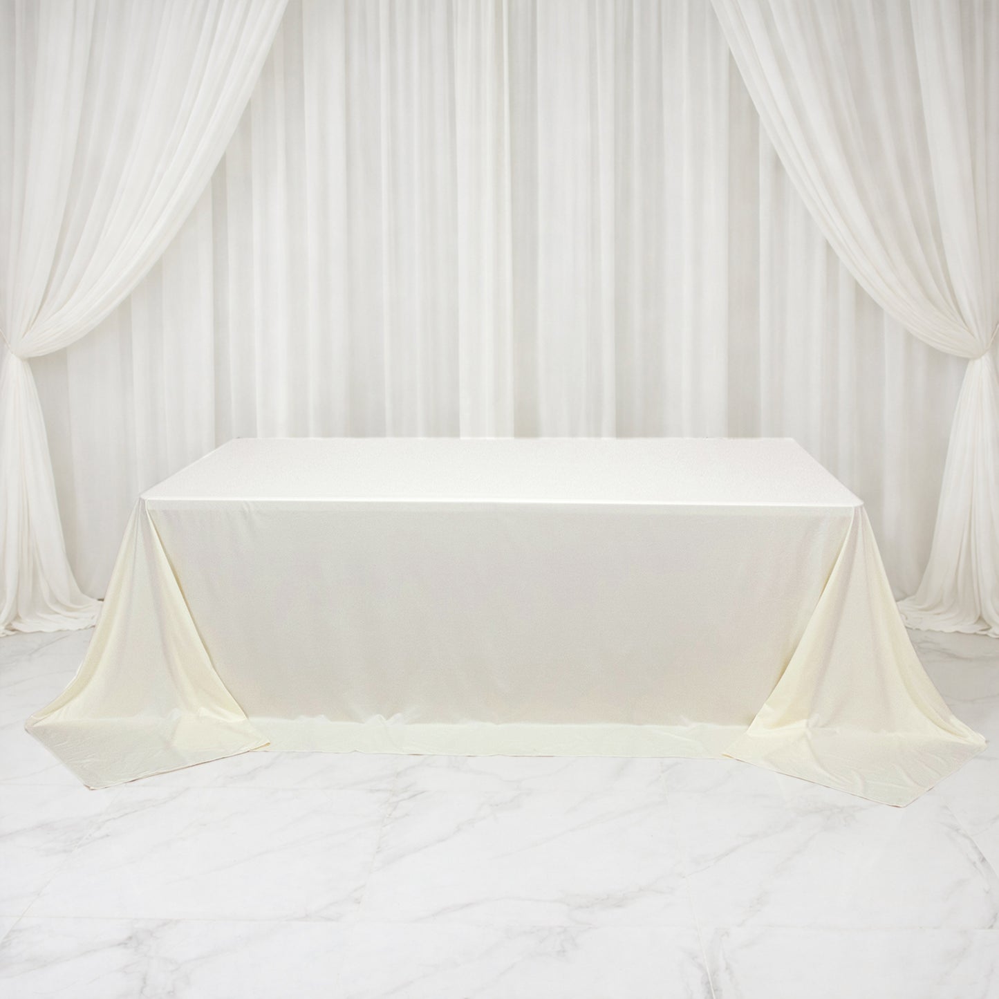 Ivory rectangular tablecloth for 8ft tables, wrinkle-free and stain-resistant.