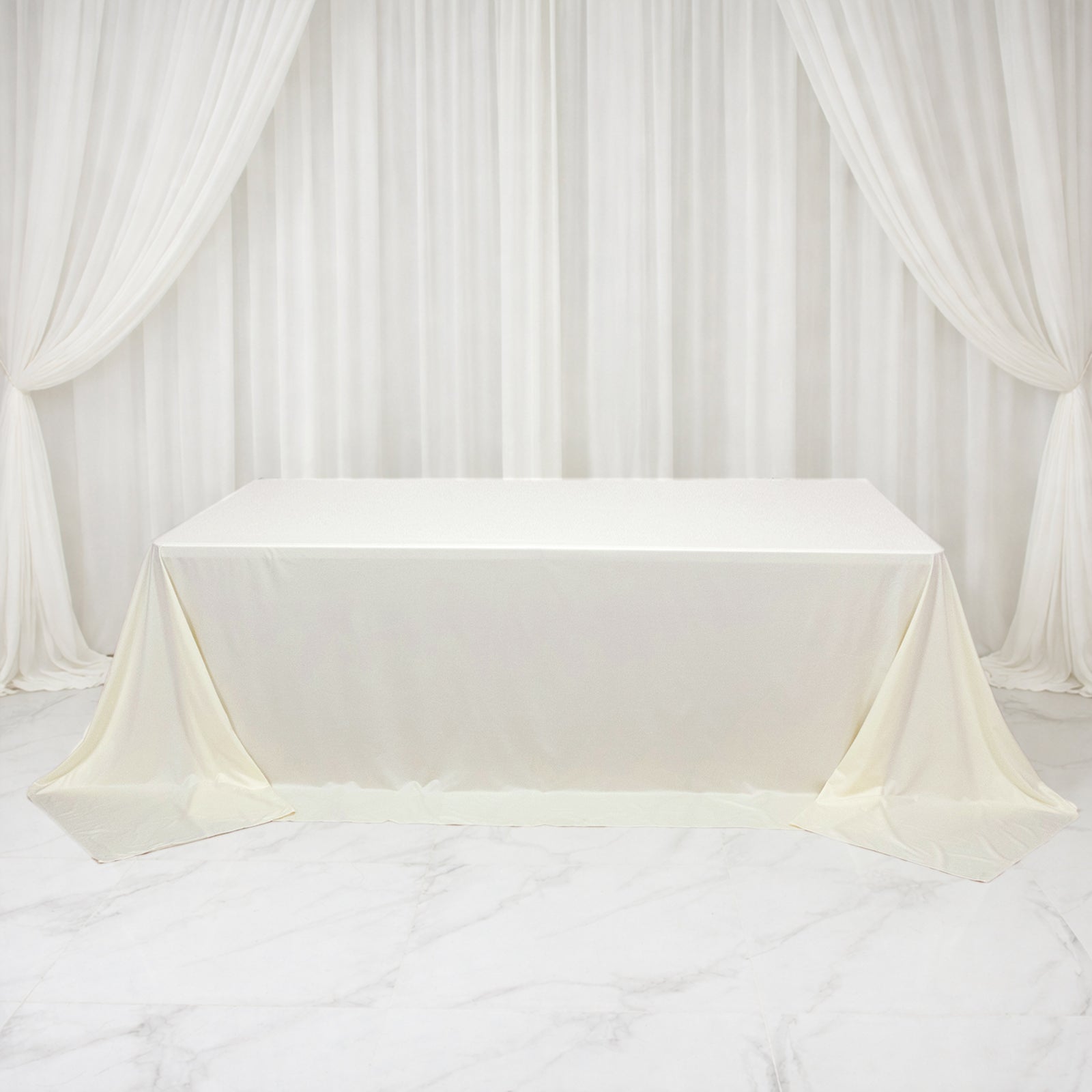 Ivory rectangular tablecloth for 8ft tables, wrinkle-free and stain-resistant.
