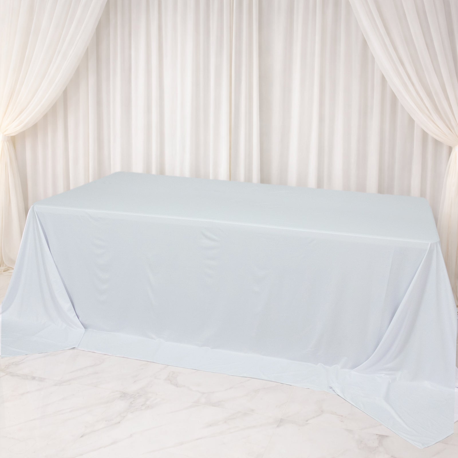 Light blue rectangular tablecloth for 8ft tables, wrinkle-free and stain-resistant.
