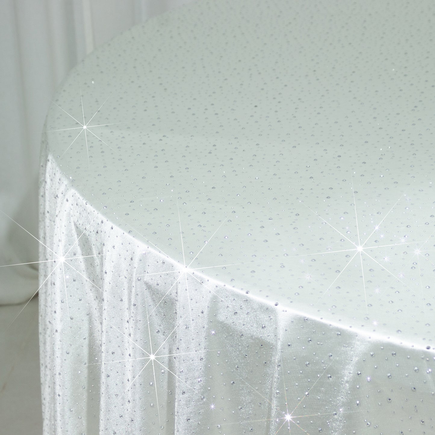 Pearl white round tablecloth with rhinestone accents, seamless and wrinkle-free.