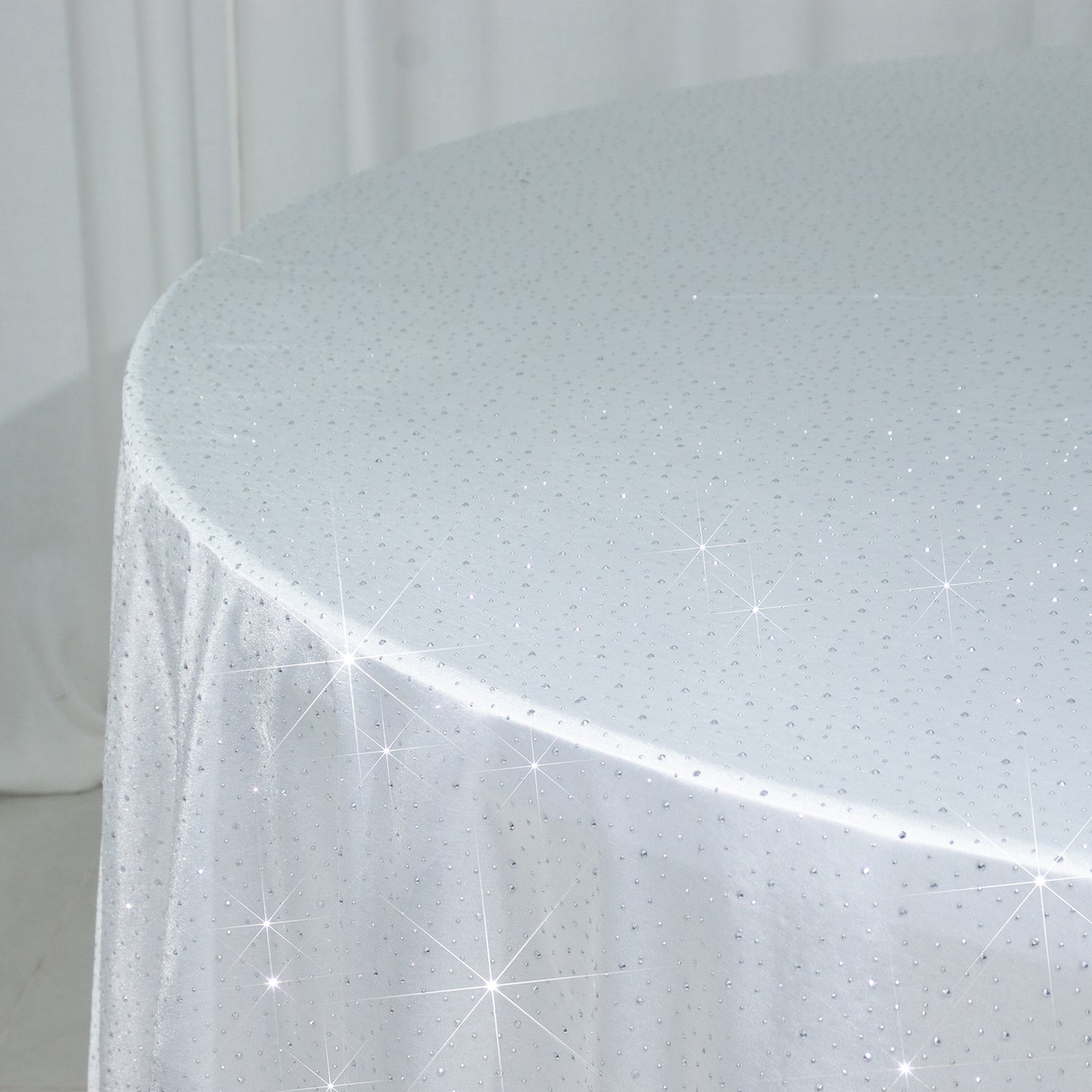 White round tablecloth with rhinestone accents, seamless and wrinkle-free.