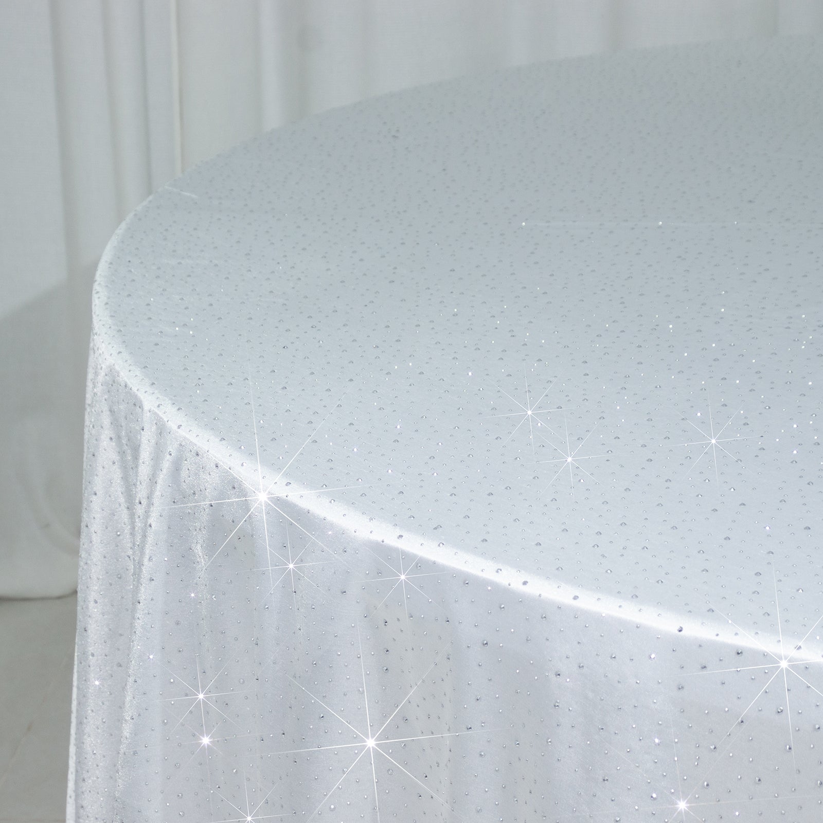 White round tablecloth with rhinestone accents, seamless and wrinkle-free.