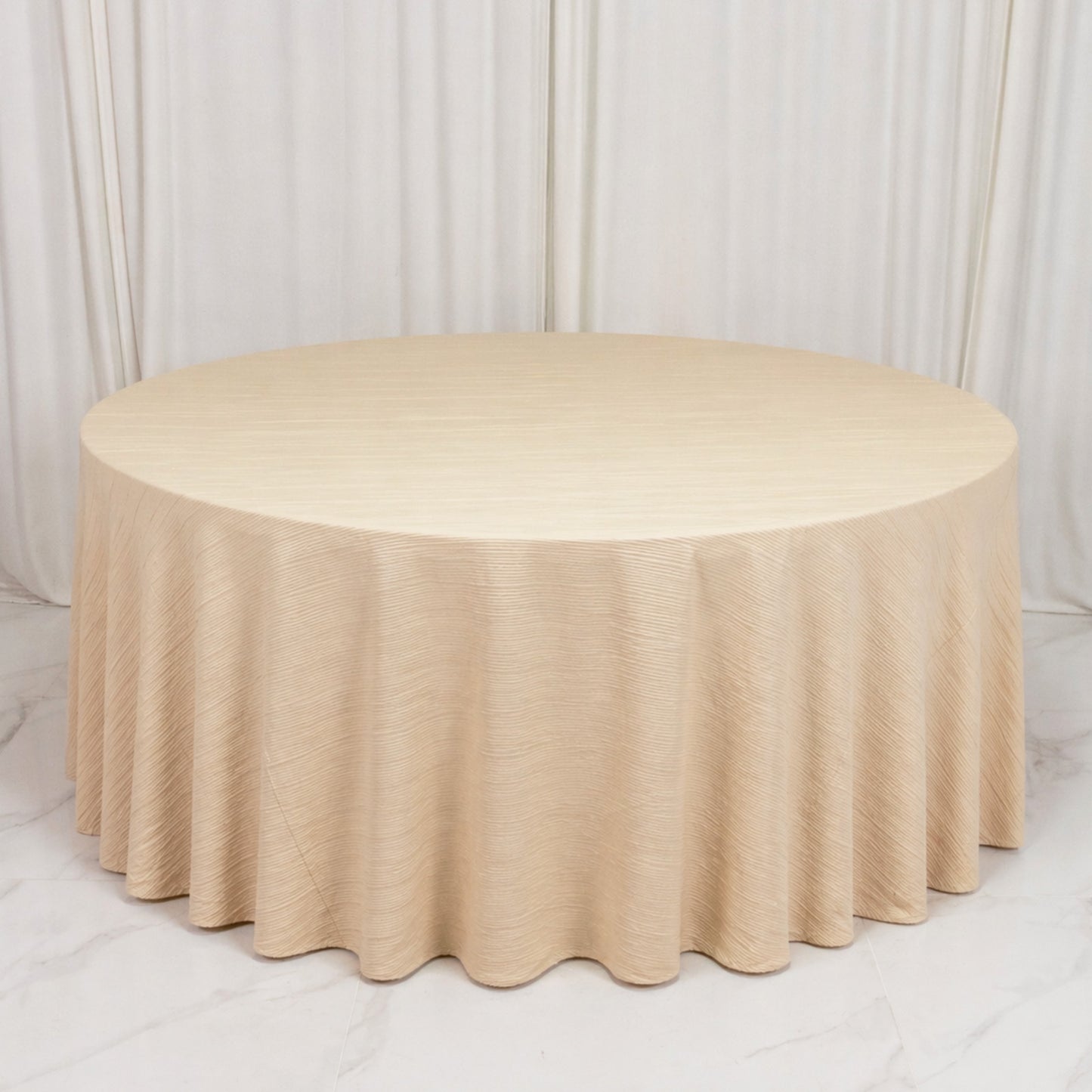 Beige accordion pleated scuba tablecloth 120" round, wrinkle-free and stain-resistant.