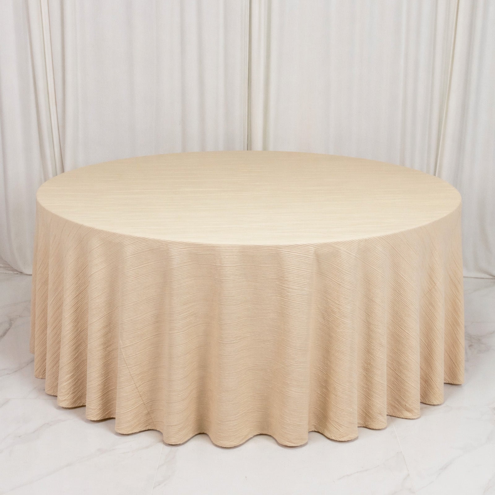 Beige accordion pleated scuba tablecloth 120" round, wrinkle-free and stain-resistant.