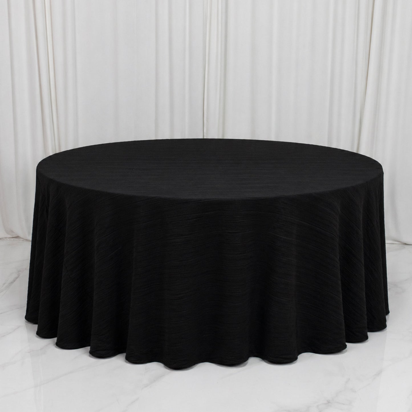 Black accordion pleated scuba tablecloth, 120" round, wrinkle-free and stain-resistant.