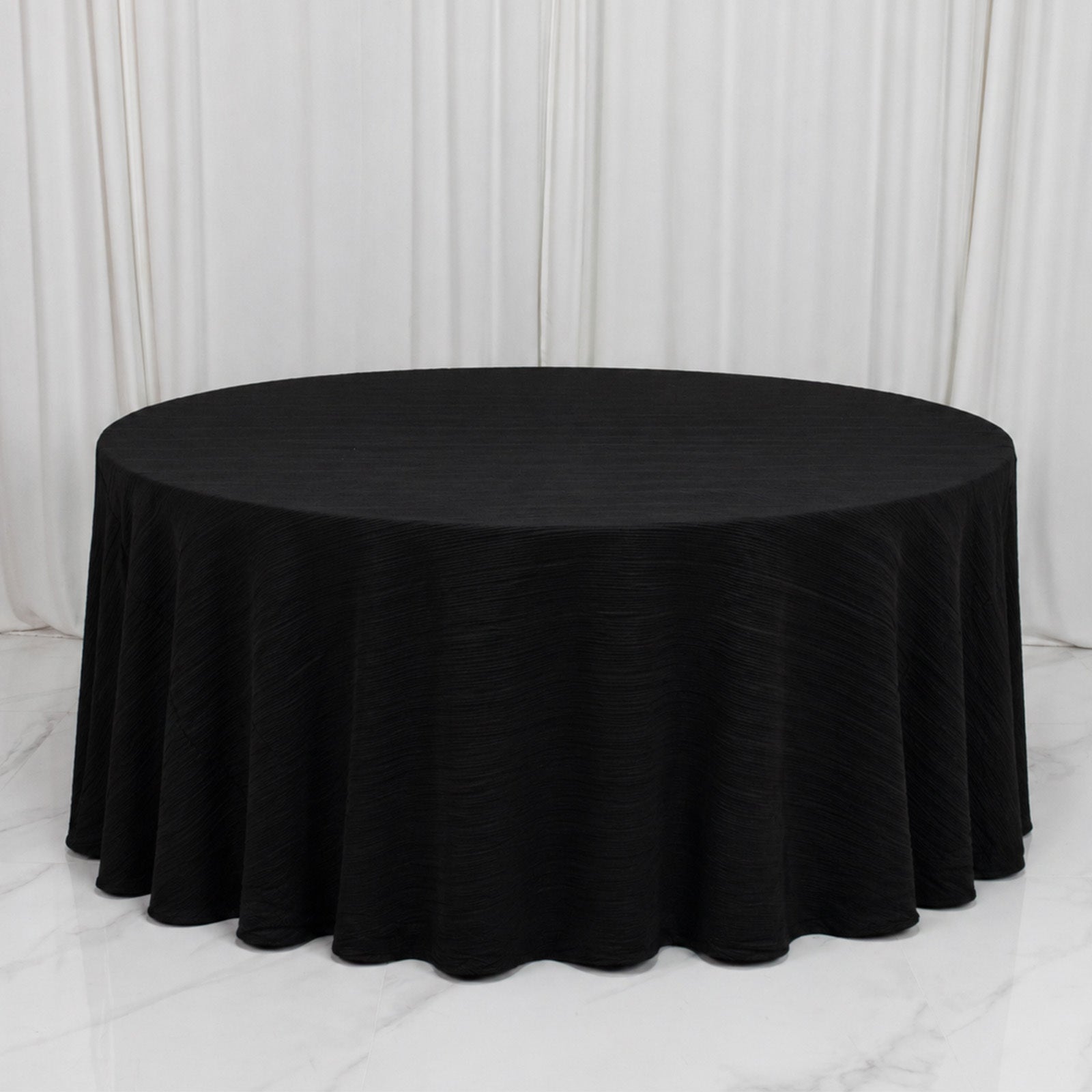 Black accordion pleated scuba tablecloth, 120" round, wrinkle-free and stain-resistant.