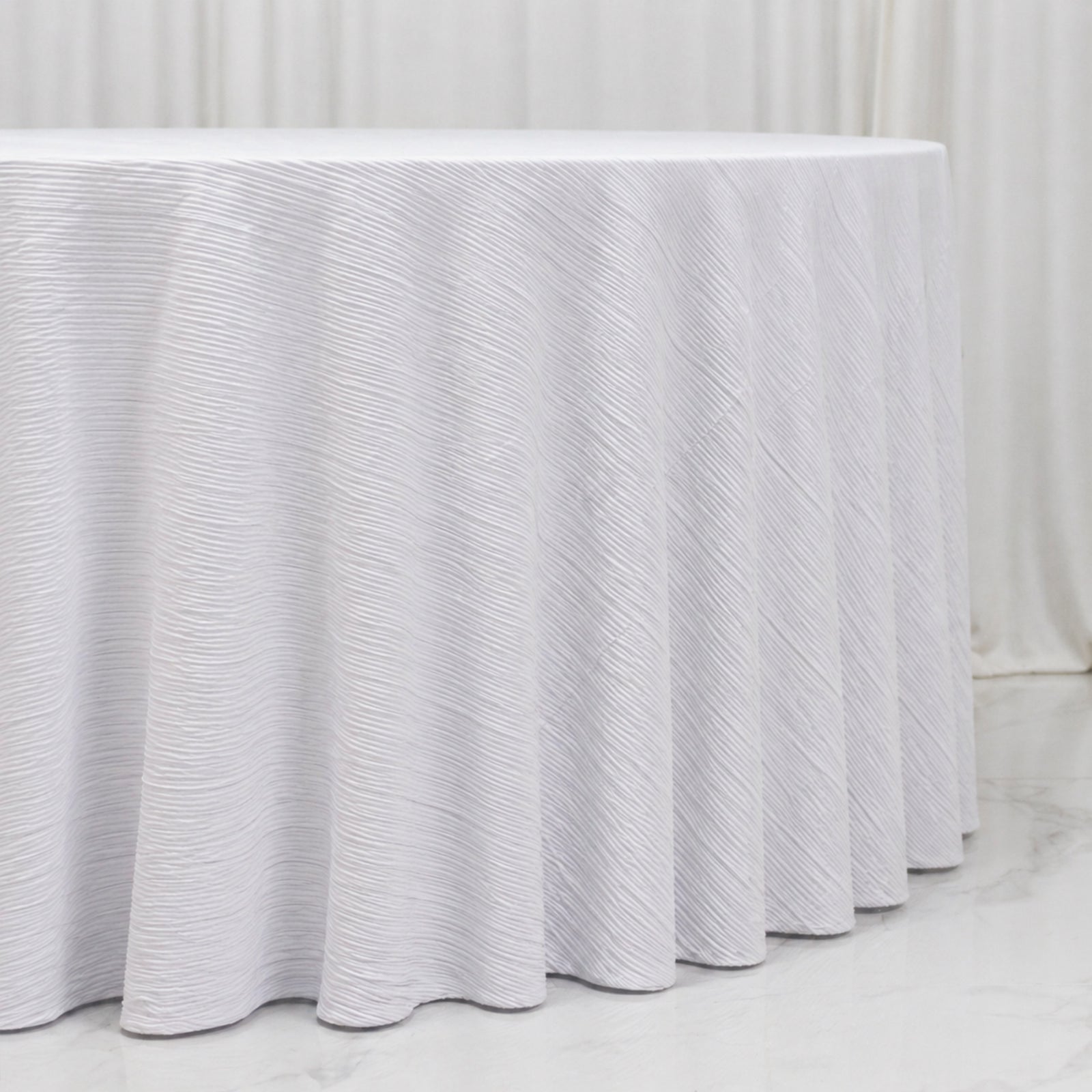 White accordion pleated scuba tablecloth, wrinkle-free and stain-resistant.