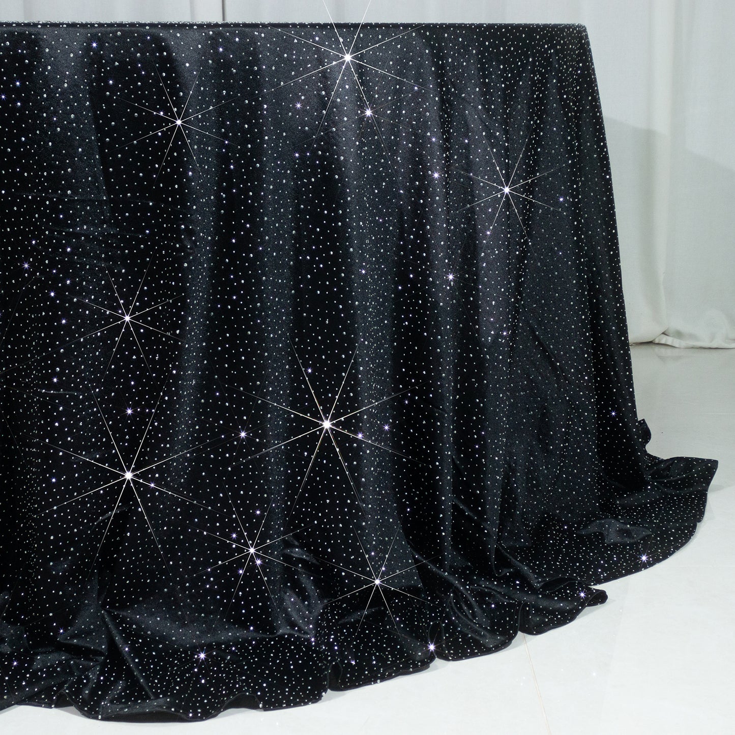 Black round tablecloth with rhinestone accents, seamless and wrinkle-free.