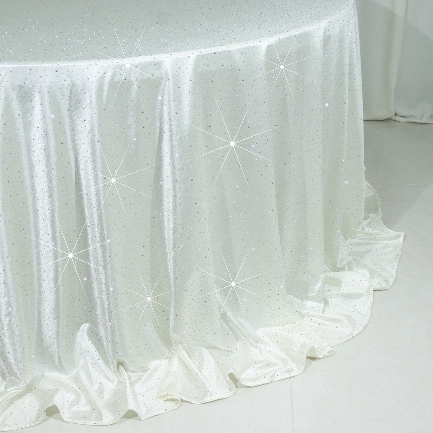 Pearl white round tablecloth with rhinestone accents, seamless and wrinkle-free.