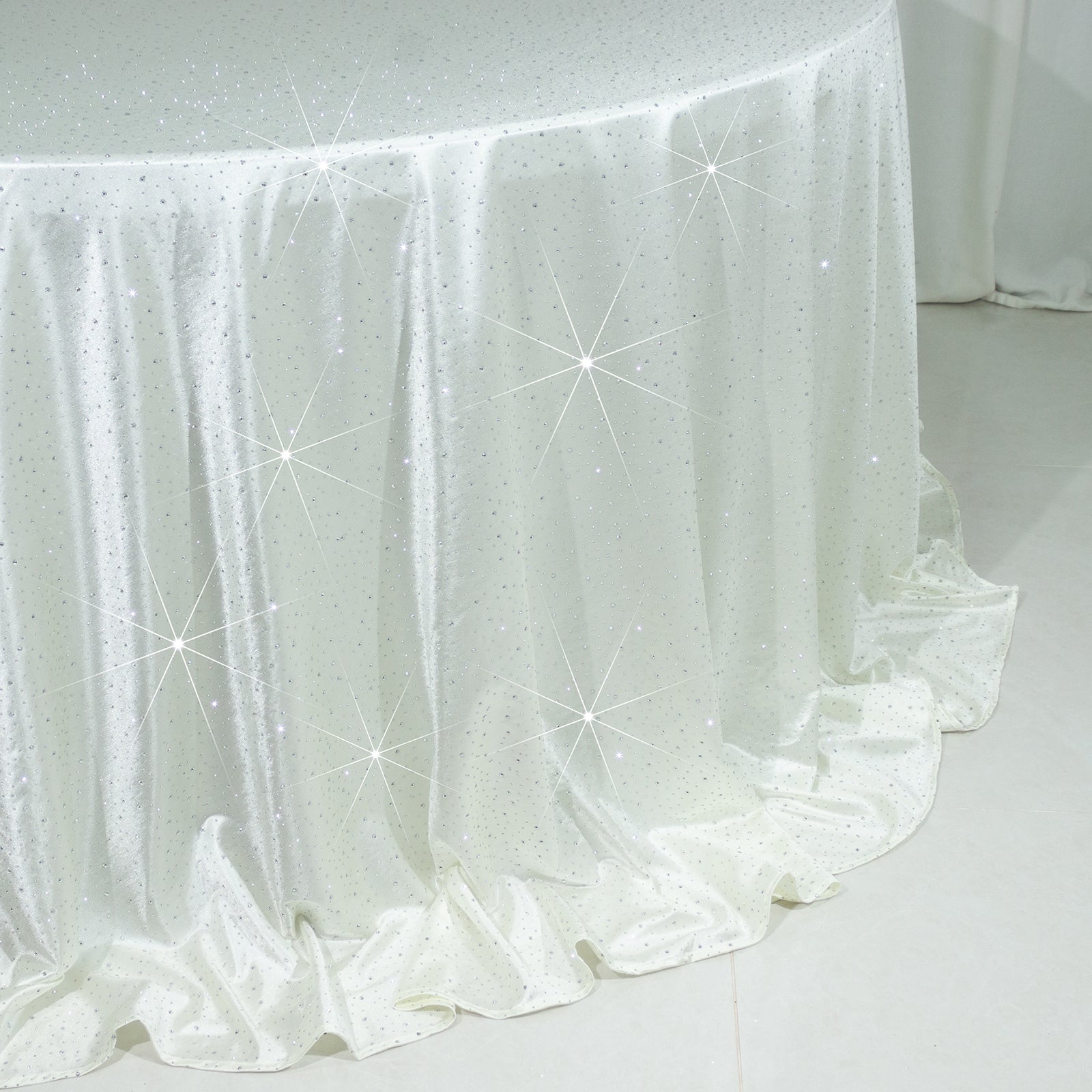 Pearl white round tablecloth with rhinestone accents, seamless and wrinkle-free.