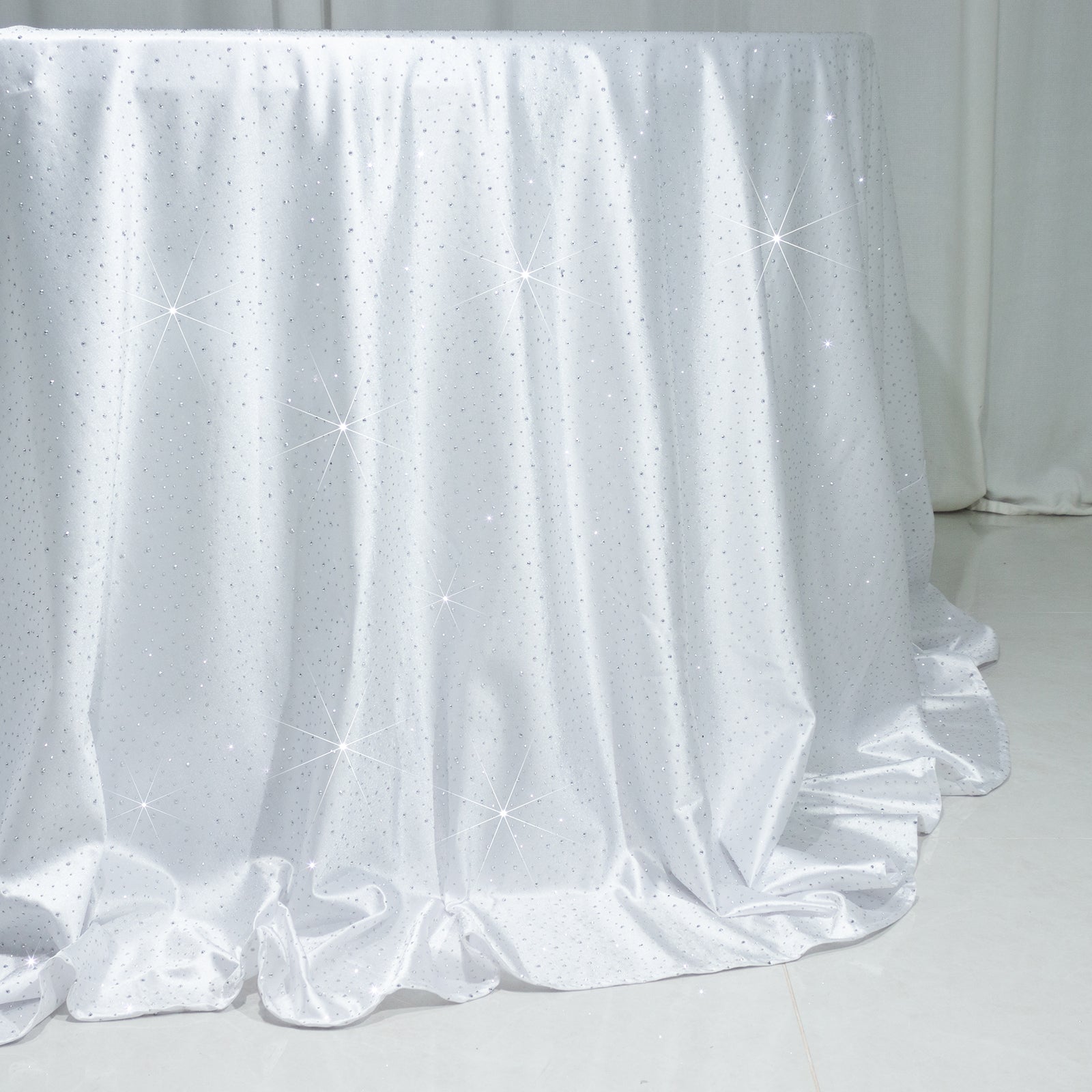 White round tablecloth with rhinestone accents, seamless and wrinkle-free.