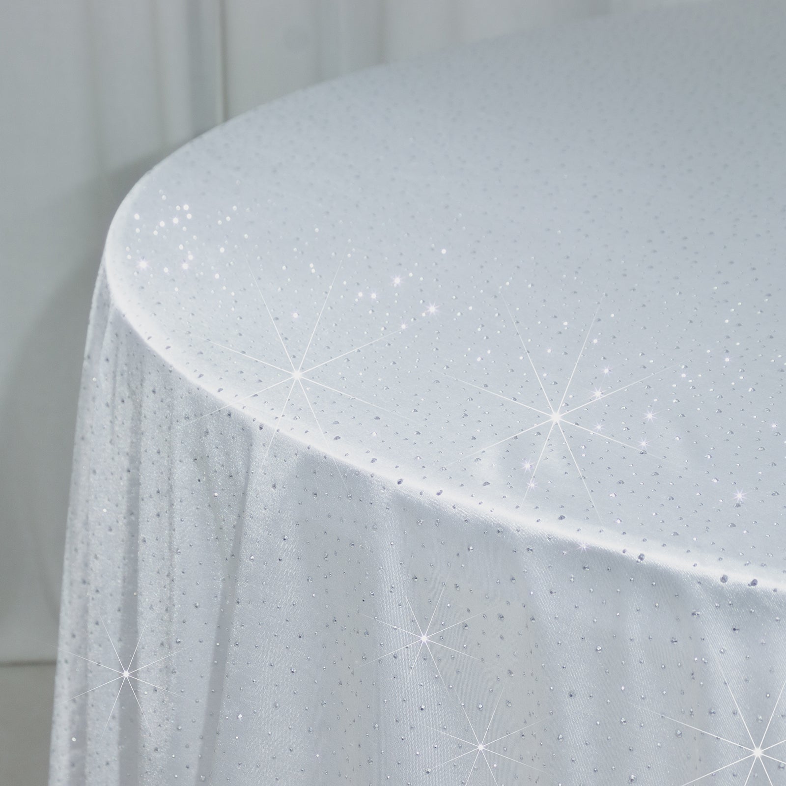 White round tablecloth with rhinestone accents, seamless and wrinkle-free.