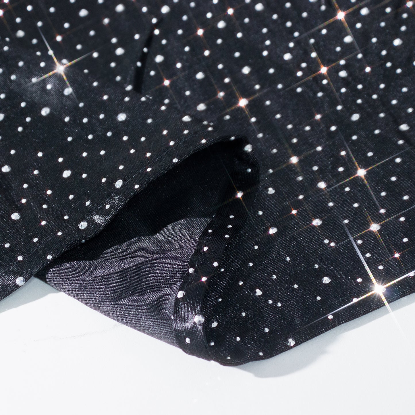 Black rectangular tablecloth with rhinestone accents, seamless and wrinkle-free.
