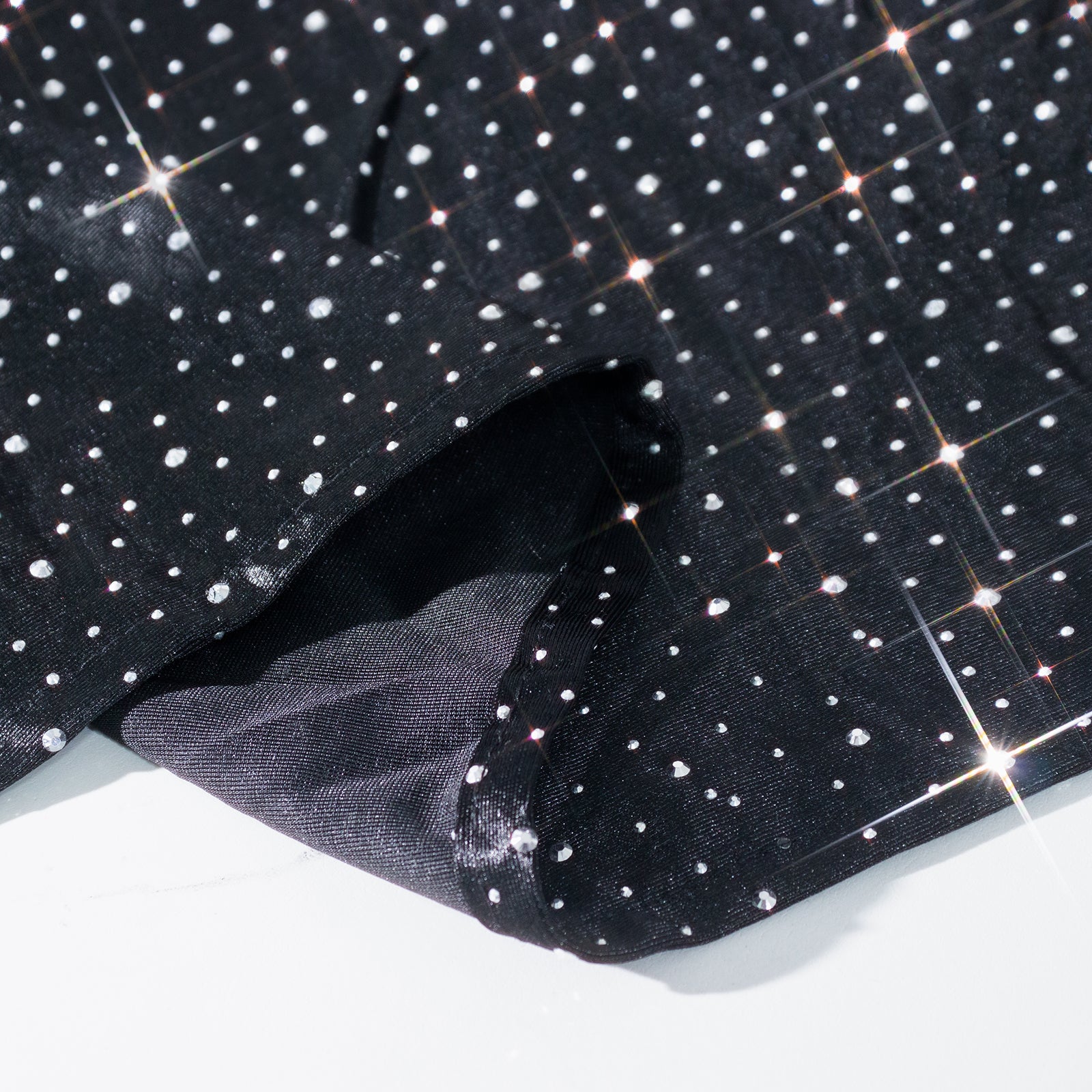 Black rectangular tablecloth with rhinestone accents, seamless and wrinkle-free.