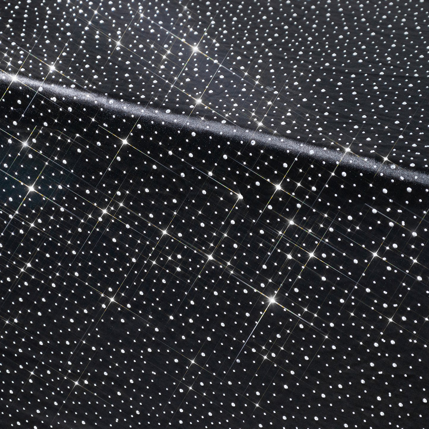 Black rectangular tablecloth with rhinestone accents, seamless and wrinkle-free.