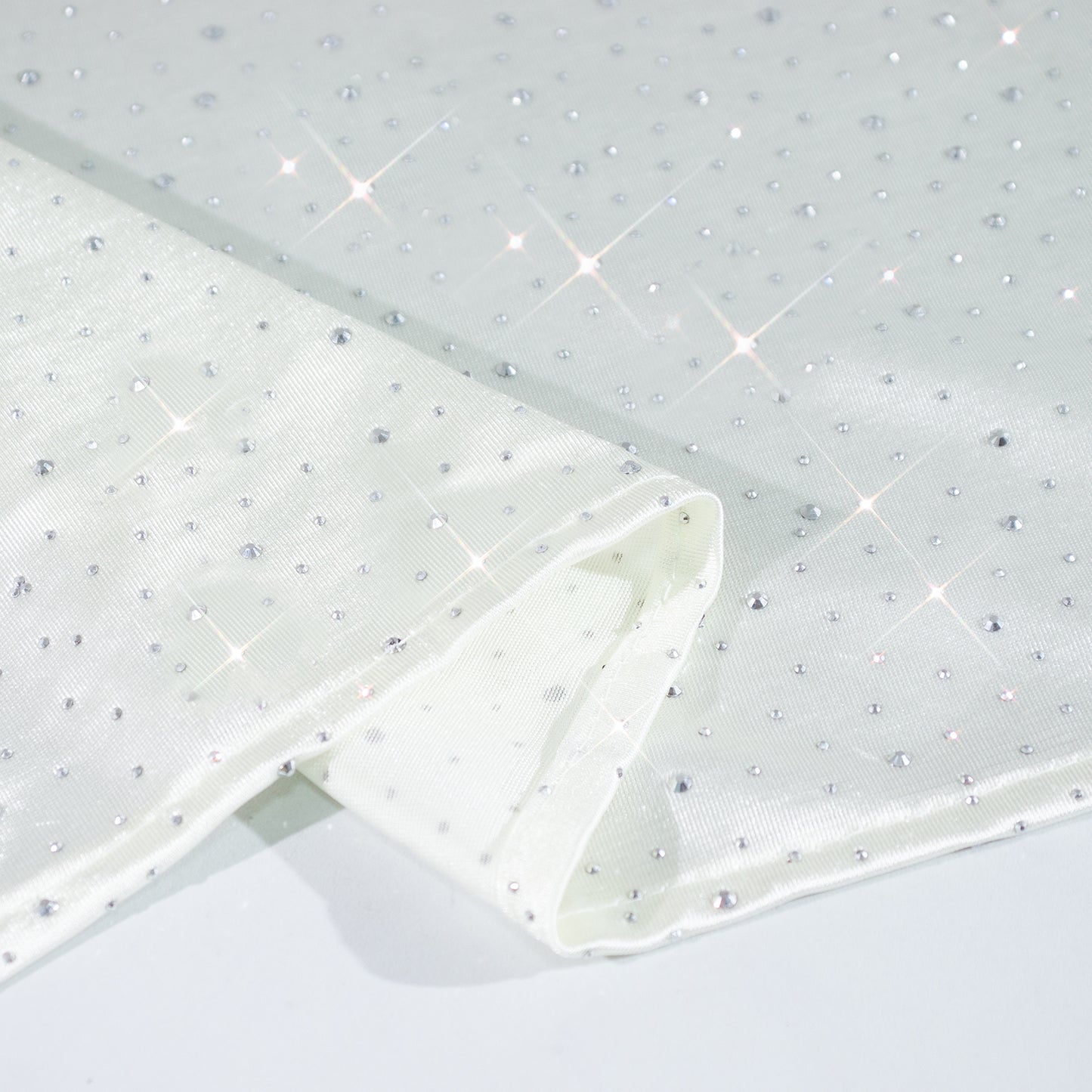 Pearl white tablecloth with rhinestone accents, seamless and wrinkle-free.
