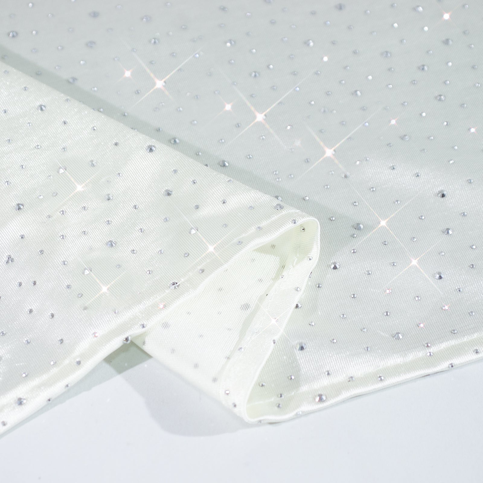 Pearl white tablecloth with rhinestone accents, seamless and wrinkle-free.