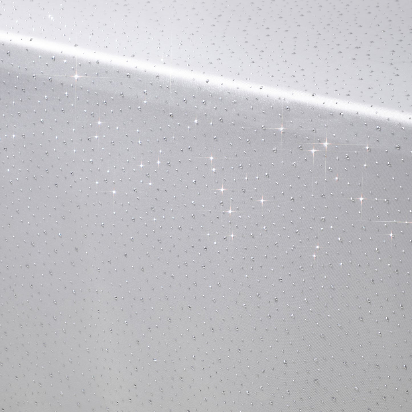 White rectangular tablecloth with rhinestone accents, seamless and wrinkle-free.
