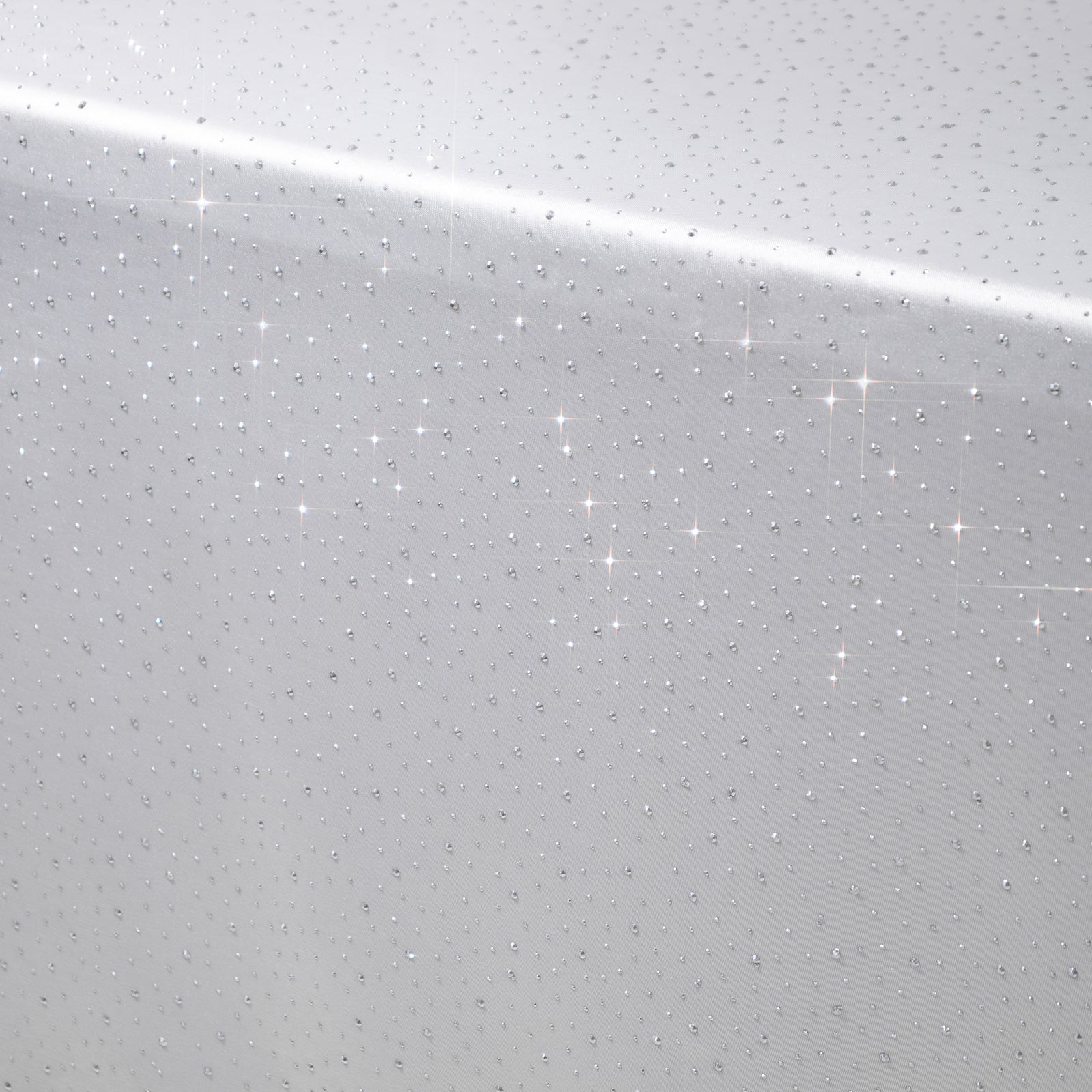 White rectangular tablecloth with rhinestone accents, seamless and wrinkle-free.