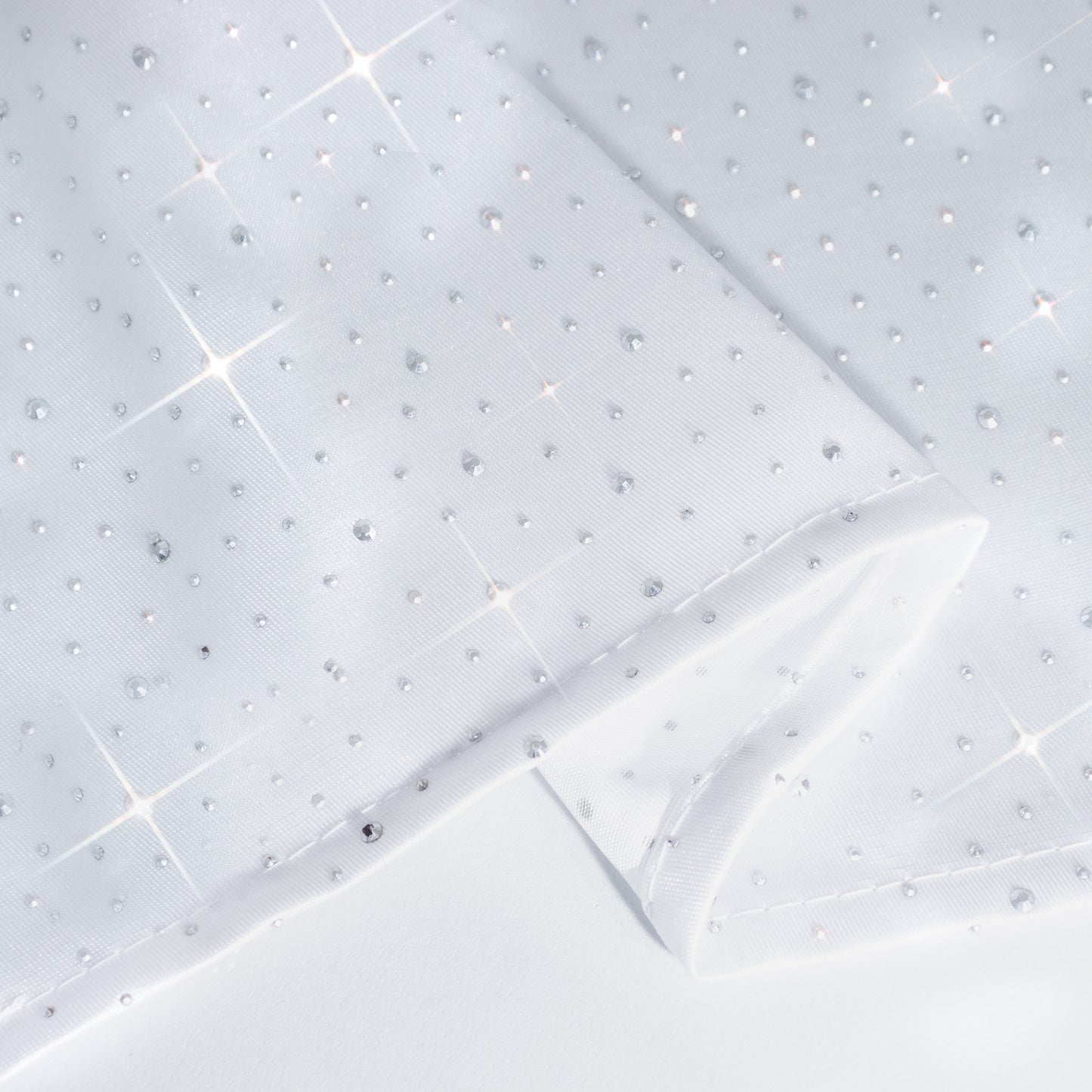 White rectangular tablecloth with rhinestone accents, seamless and wrinkle-free.
