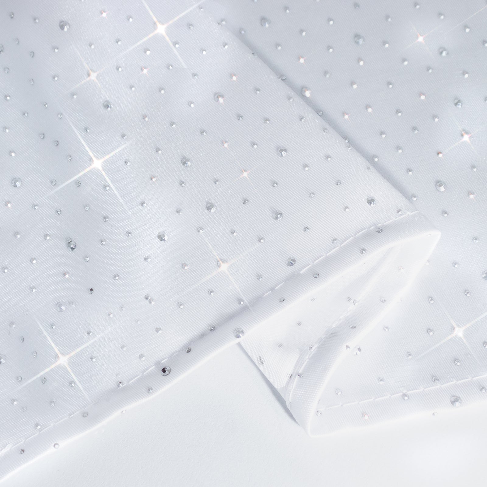 White rectangular tablecloth with rhinestone accents, seamless and wrinkle-free.