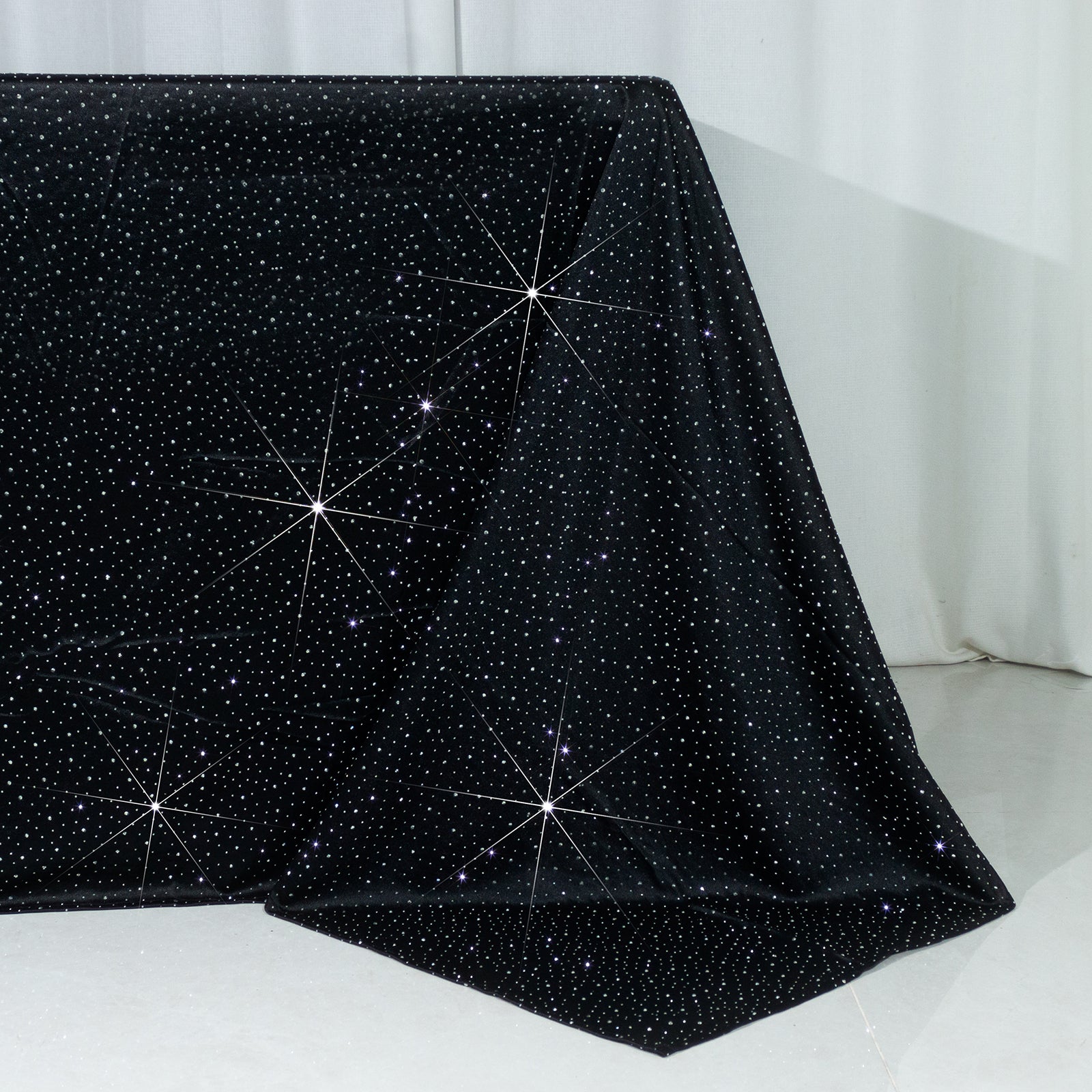 Black rectangular tablecloth with rhinestone accents, seamless and wrinkle-free.