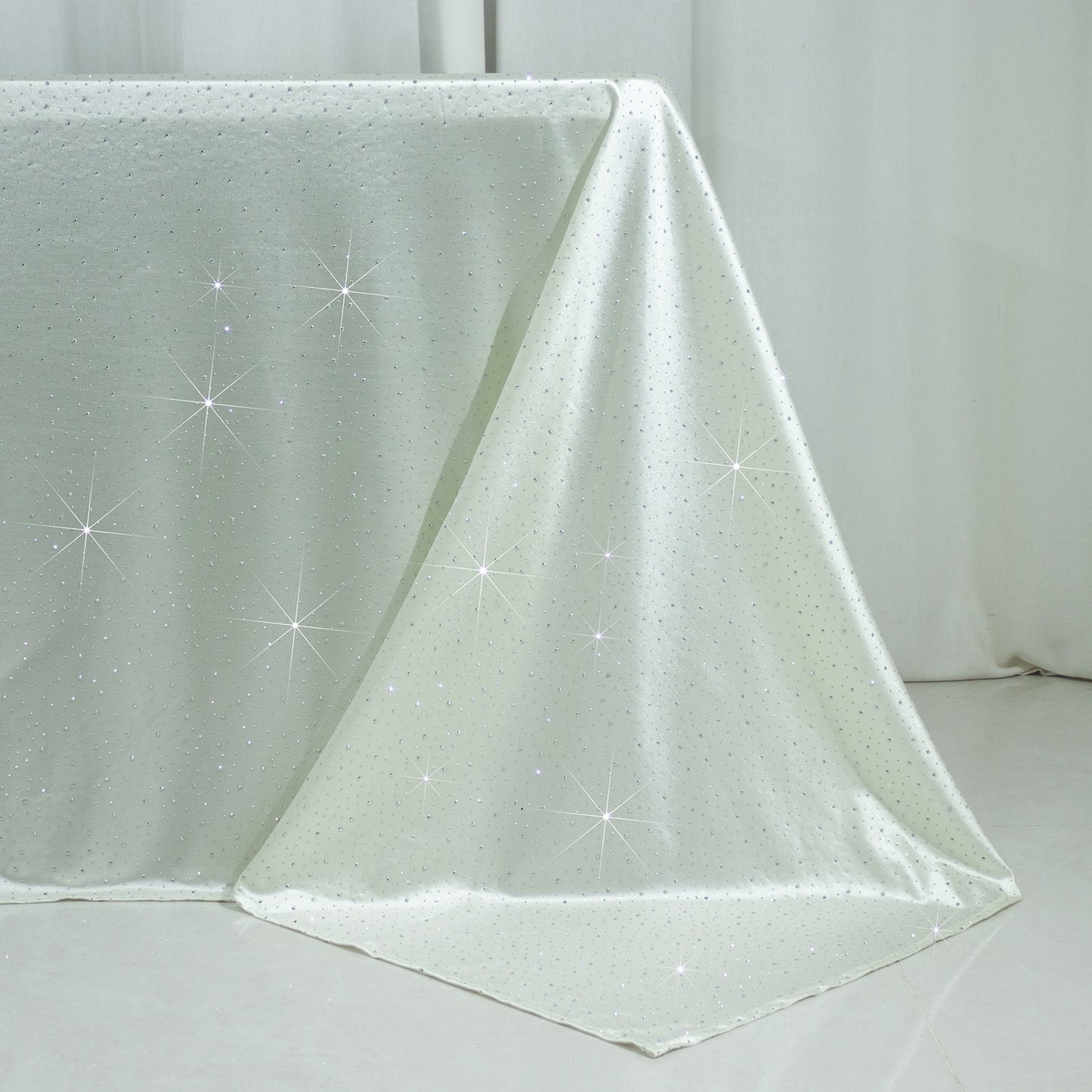 Pearl white rectangular tablecloth with rhinestone accents, seamless and wrinkle-free.