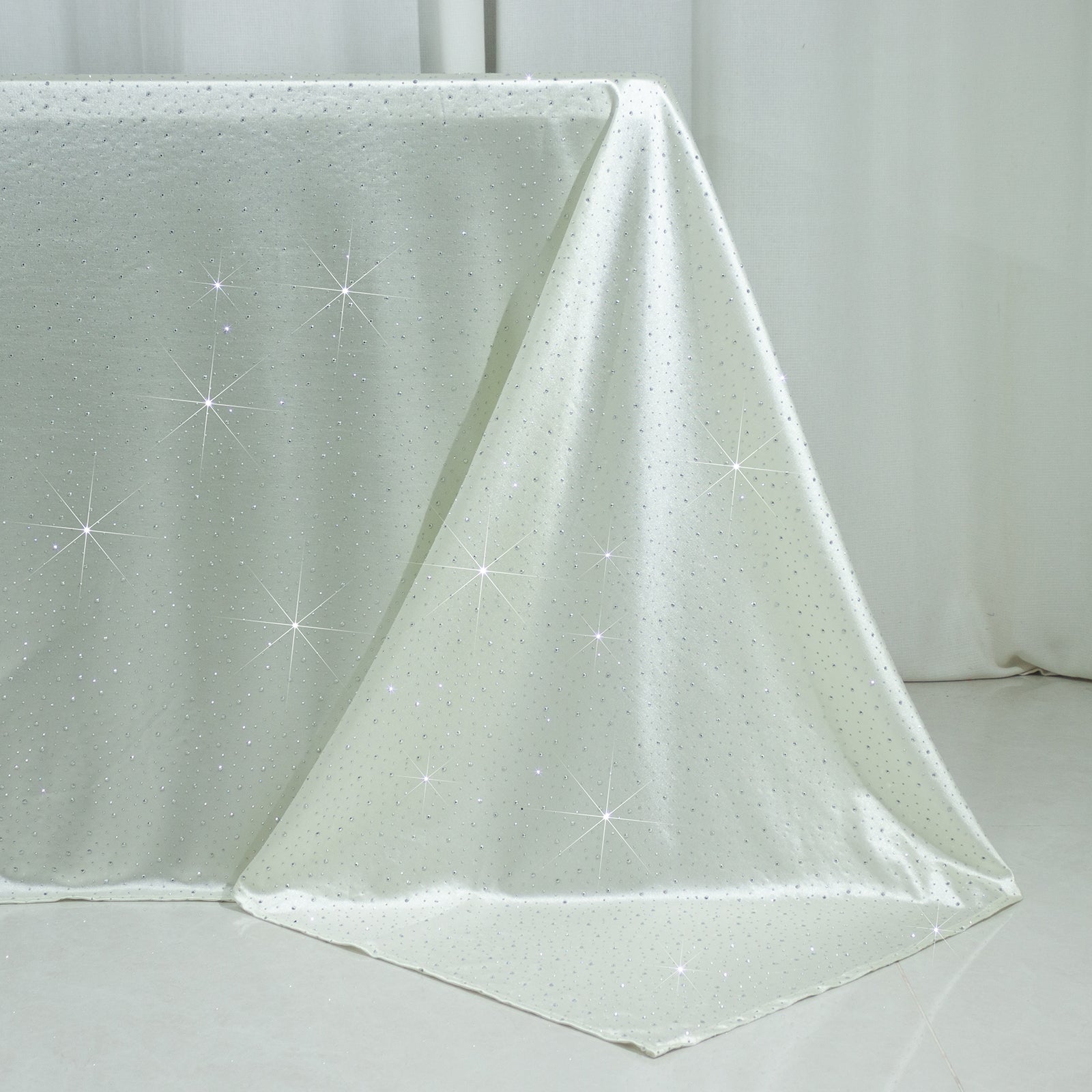 Pearl white rectangular tablecloth with rhinestone accents, seamless and wrinkle-free.