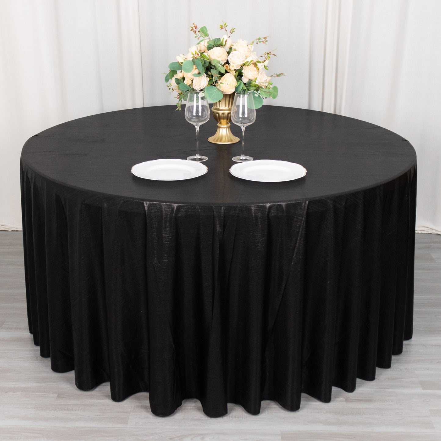 120" black shimmer sequin dots tablecloth on a round table.