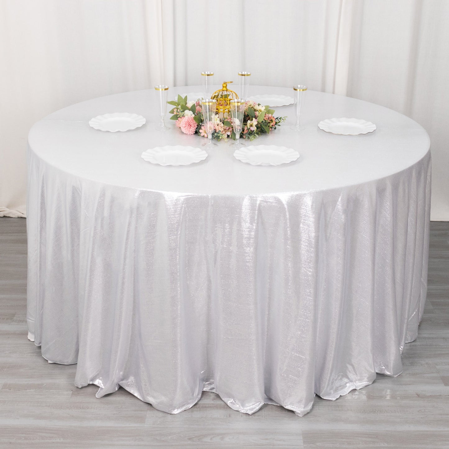 120" silver shimmer sequin dots tablecloth on a round table.