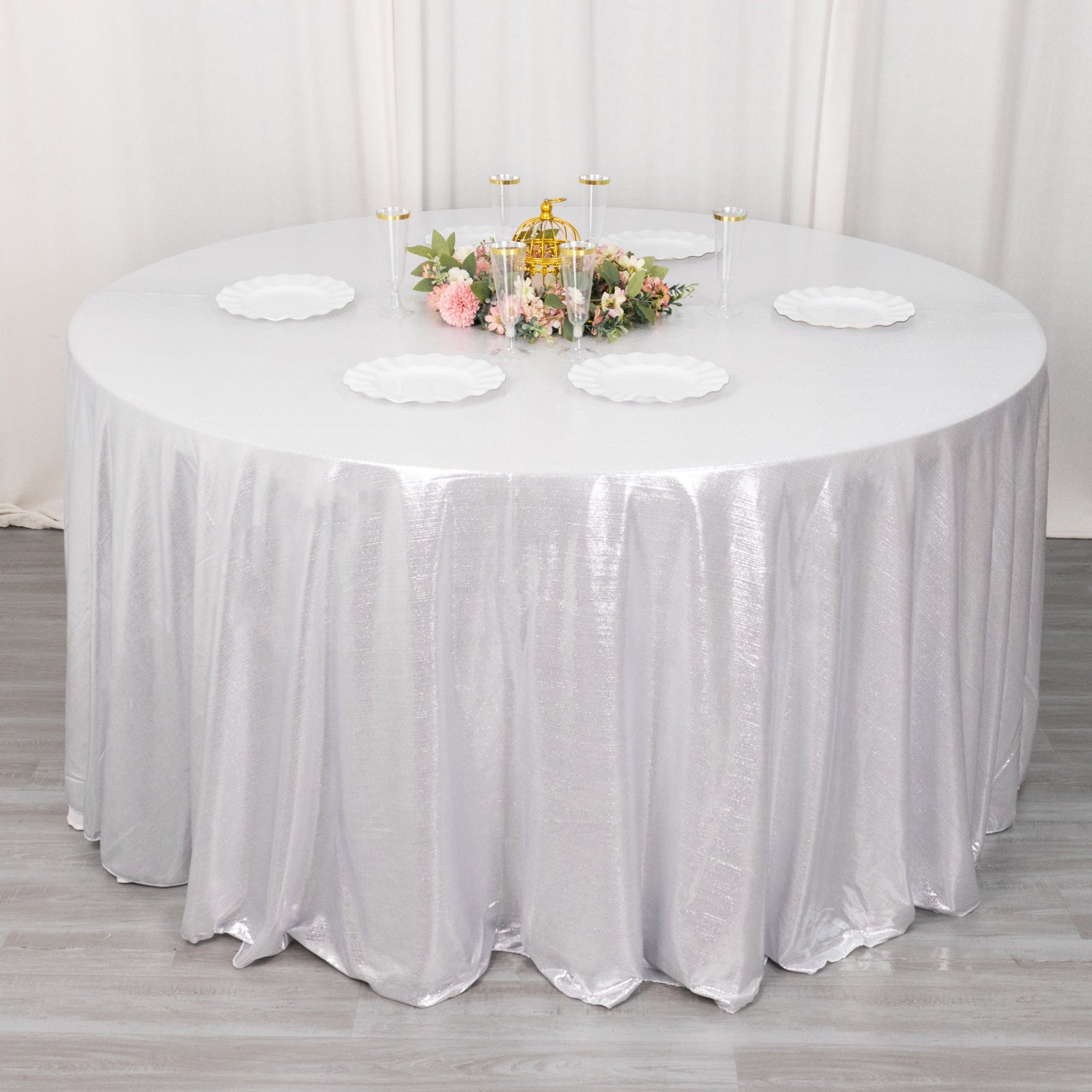 120" silver shimmer sequin dots tablecloth on a round table.