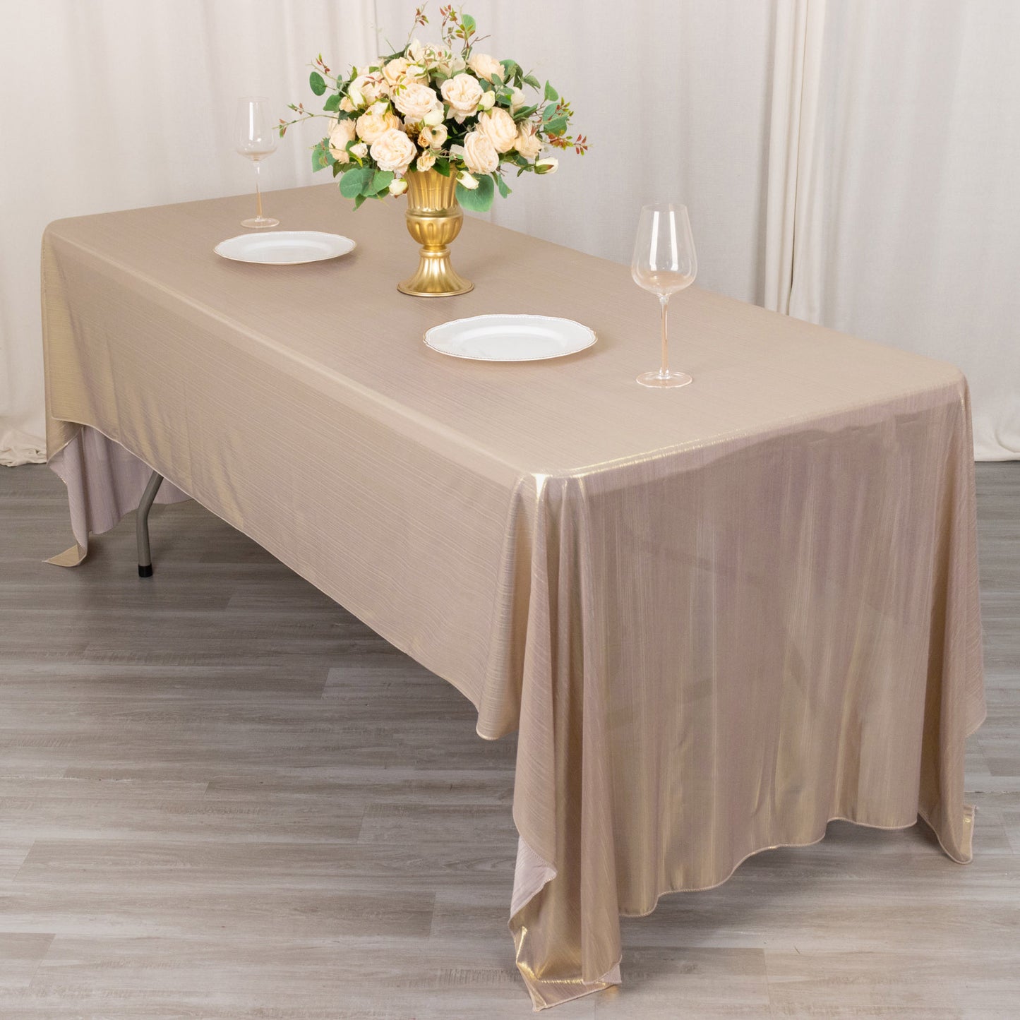 Shiny blush rectangular tablecloth with shimmer sequin dots on a banquet table.