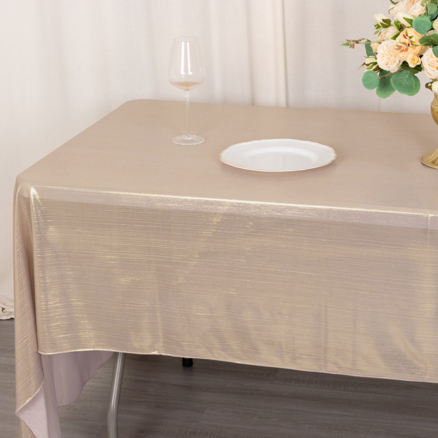 Shiny blush rectangular tablecloth with shimmer sequin dots on a table.