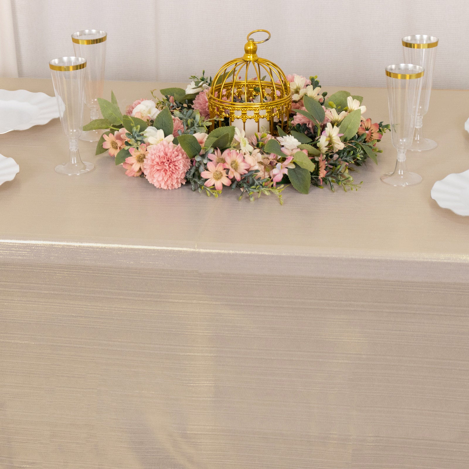 Shiny blush rectangular tablecloth with shimmer sequin dots on a decorated table.