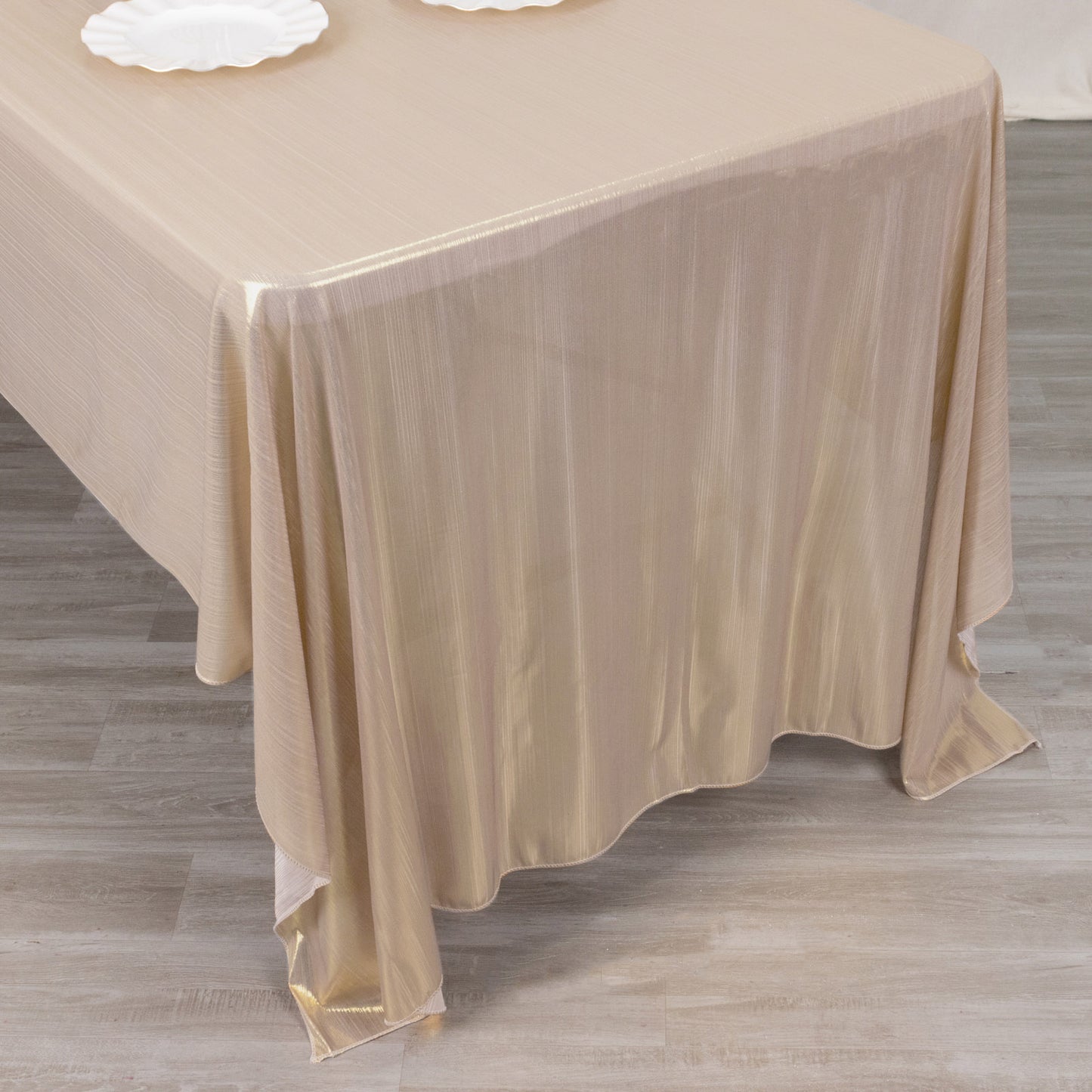Shiny blush rectangular tablecloth with shimmer sequin dots on a table.