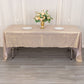Shiny blush rectangular tablecloth with shimmer sequin dots on a dining table.