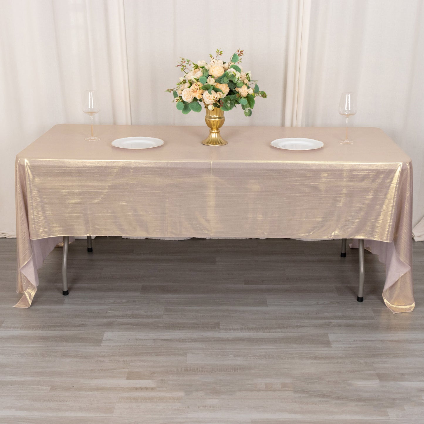 Shiny blush rectangular tablecloth with shimmer sequin dots on a dining table.