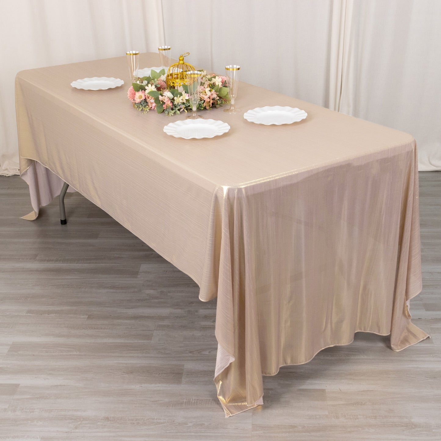 Shiny blush rectangular tablecloth with shimmer sequin dots on a dining table.