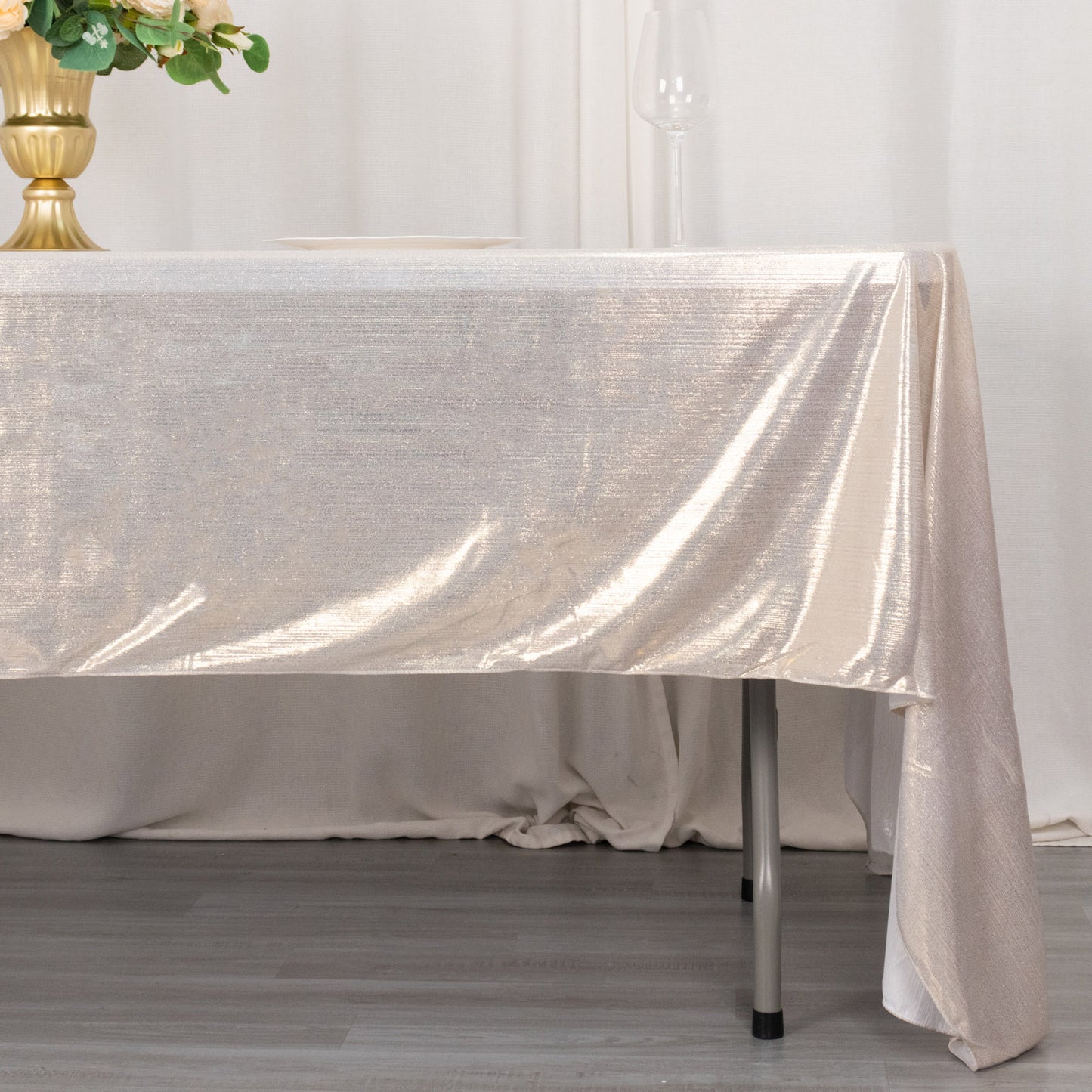 Shiny beige rectangular tablecloth with shimmer sequin dots on a table.