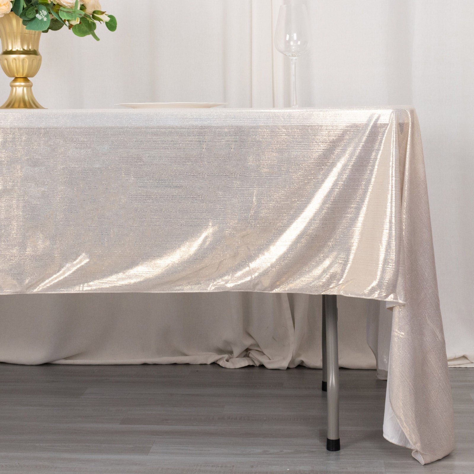 Shiny beige rectangular tablecloth with shimmer sequin dots on a table.