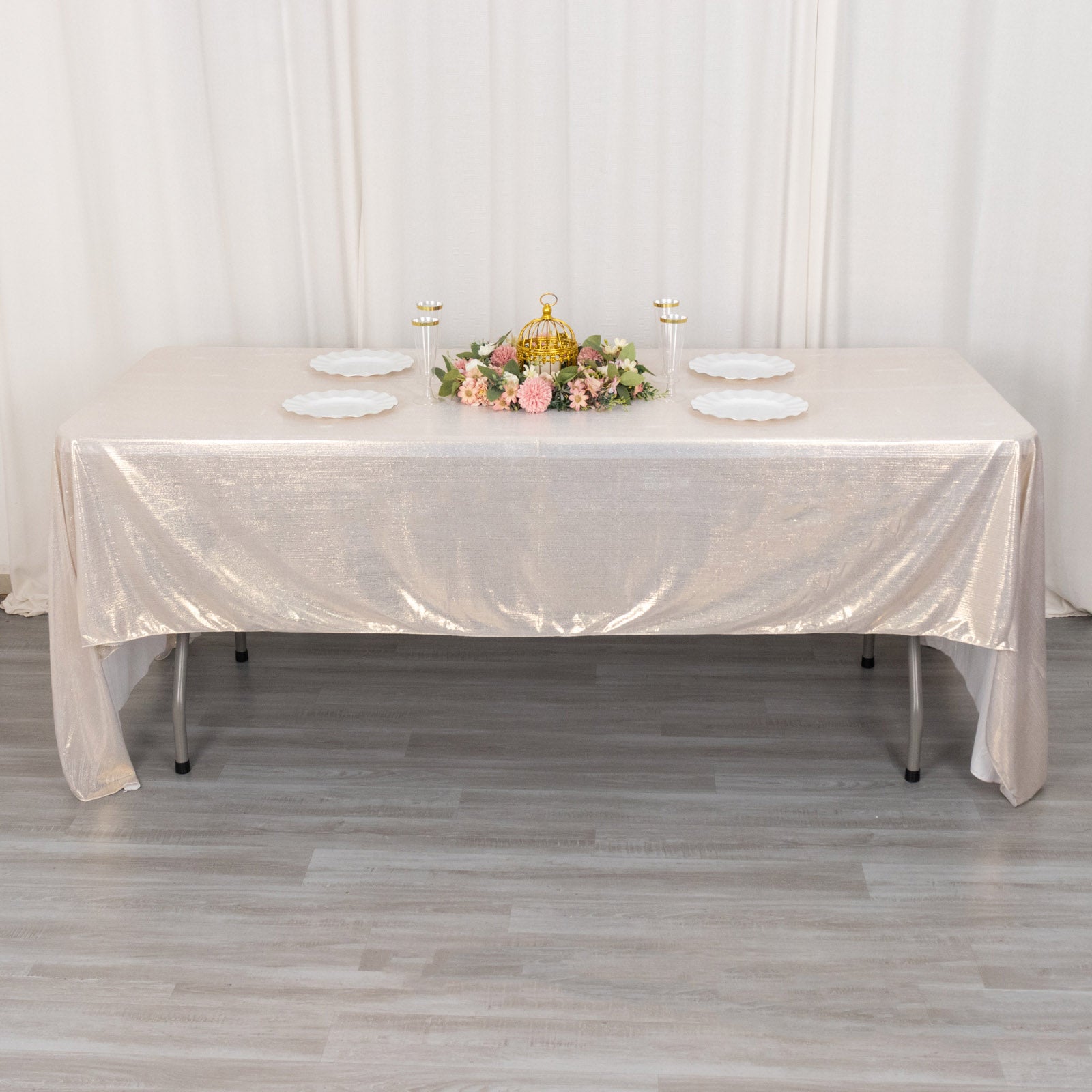 Shiny beige rectangular tablecloth with shimmer sequin dots on a table.
