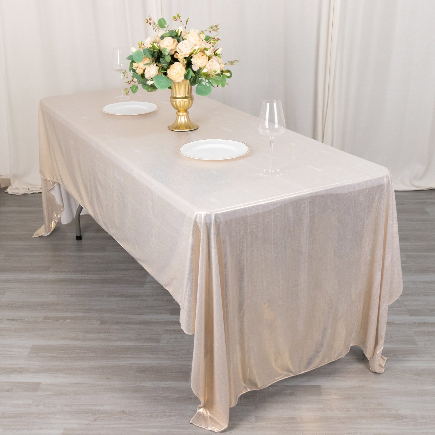 Shiny beige rectangular tablecloth with shimmer sequin dots on a dining table.