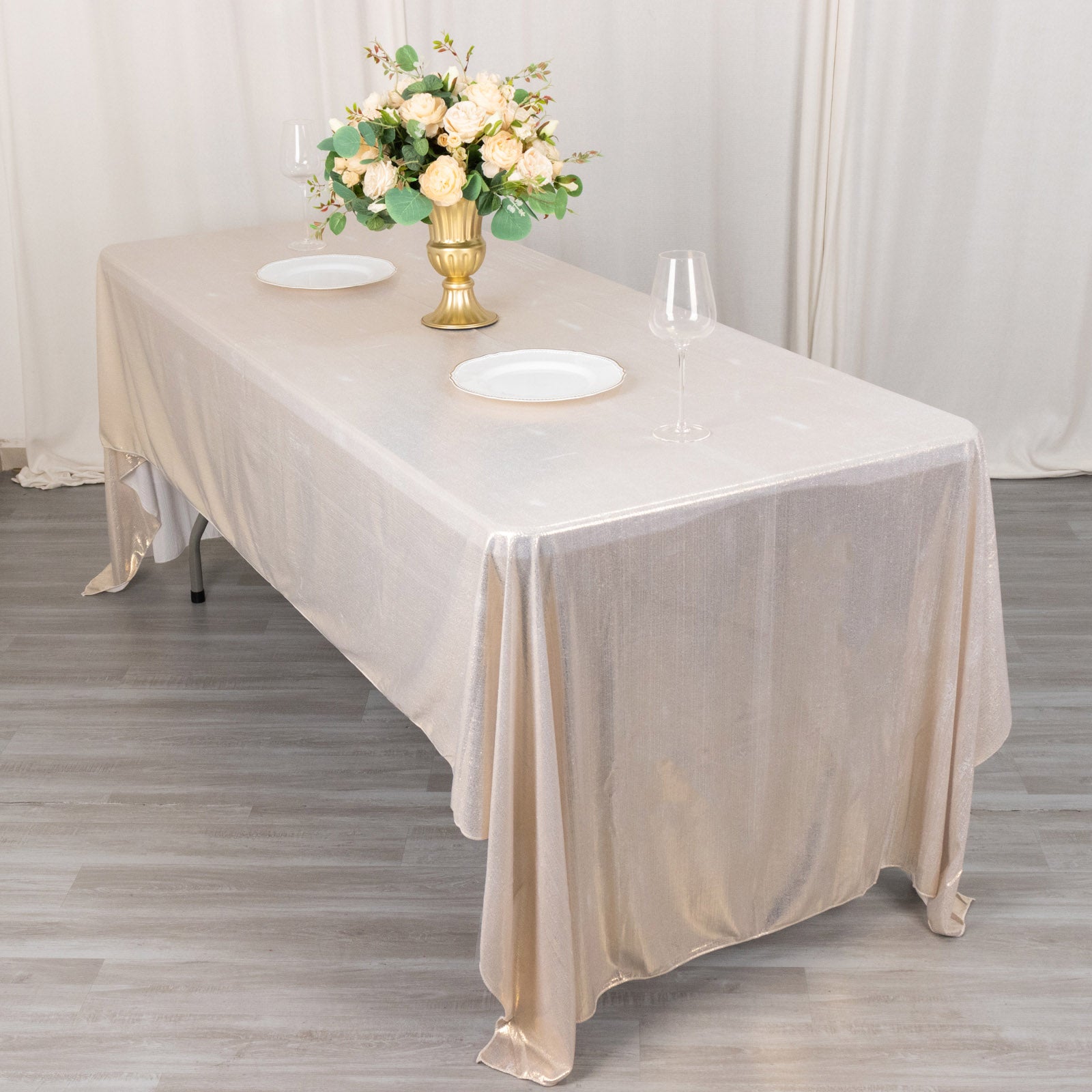 Shiny beige rectangular tablecloth with shimmer sequin dots on a dining table.